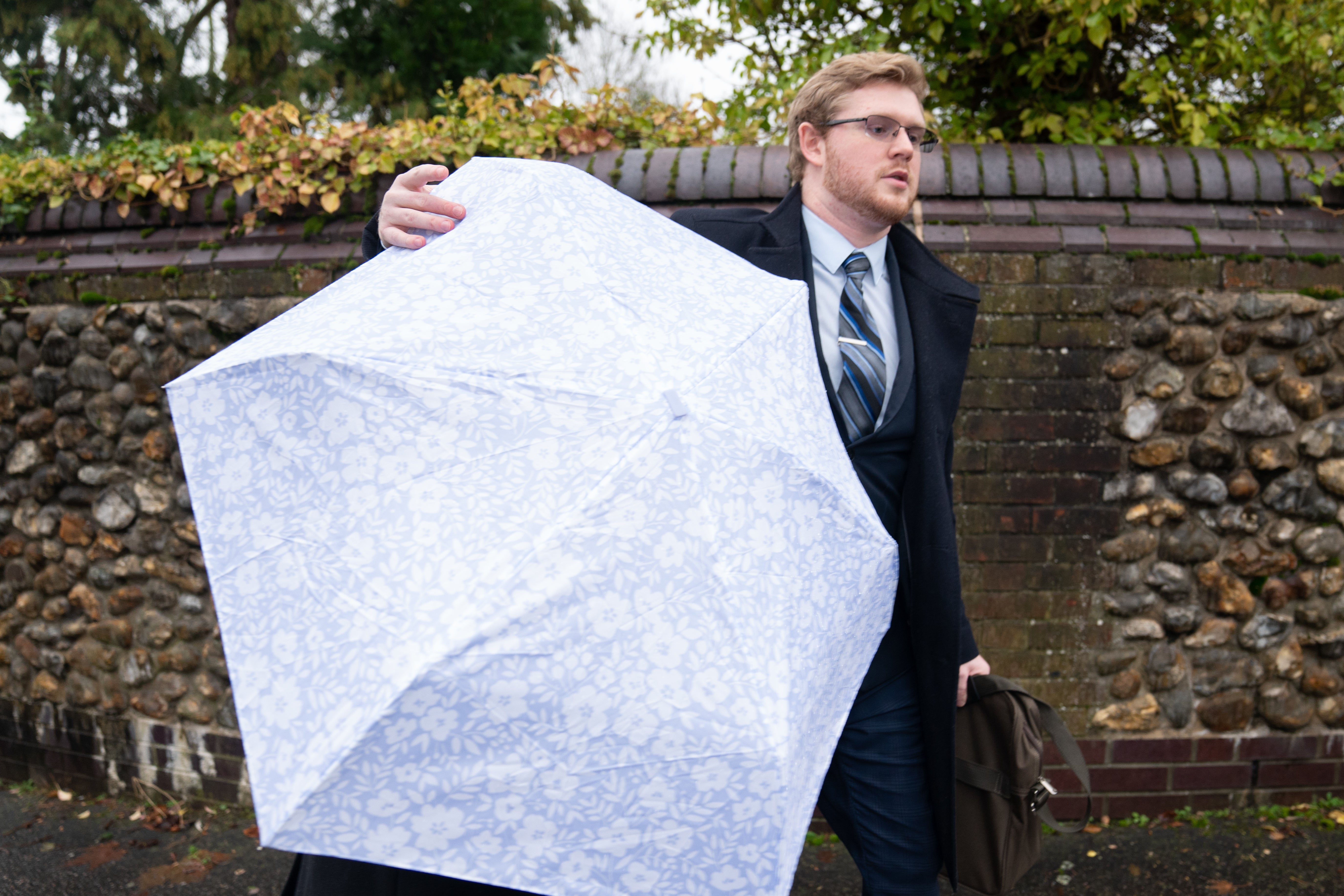 Mikayla Hayes seen leaving Norwich Crown Court being hidden by an umbrella