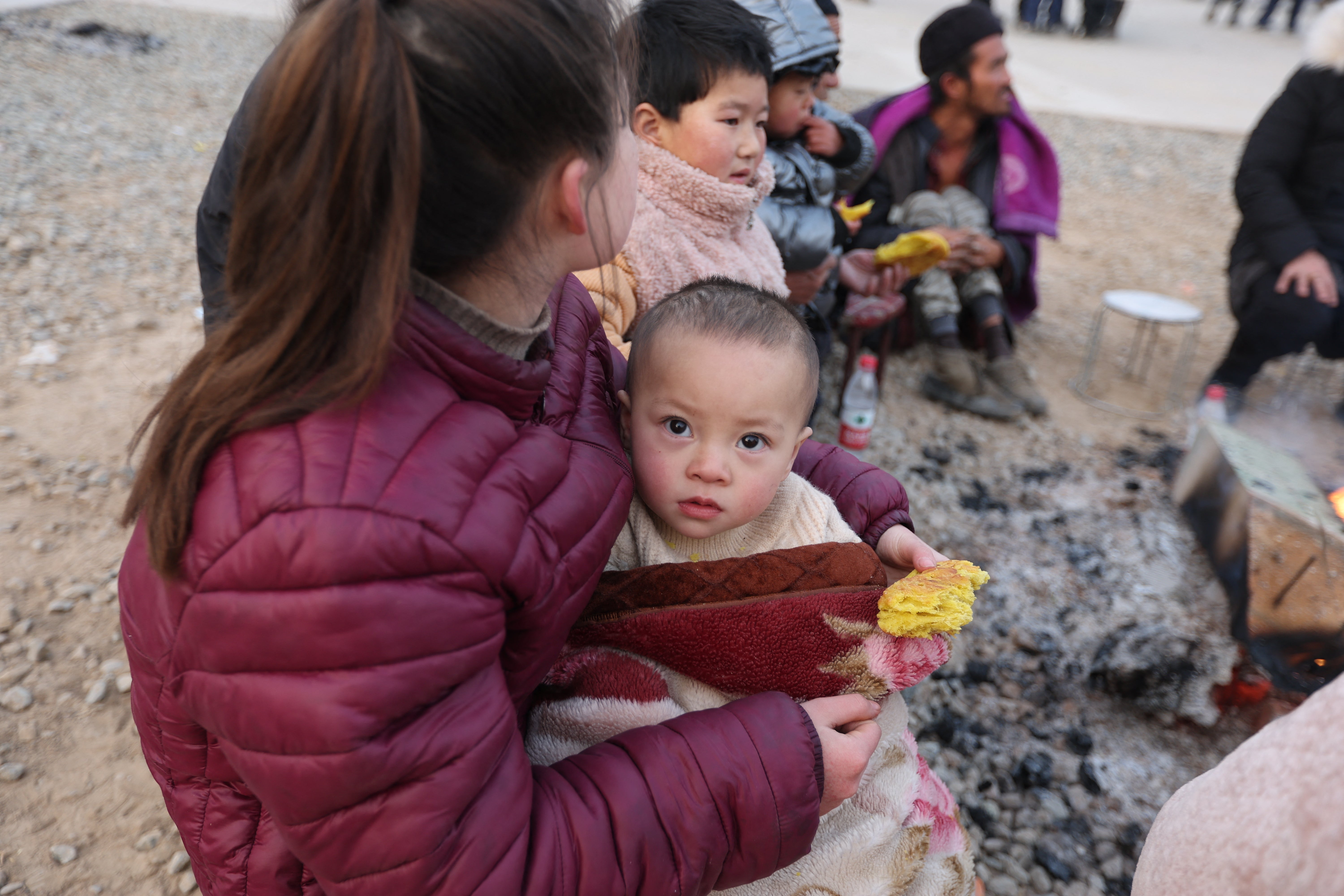 Residents gather outdoors the morning after an earthquake in Dahejia, Jishishan County, in northwest China’s Gansu province