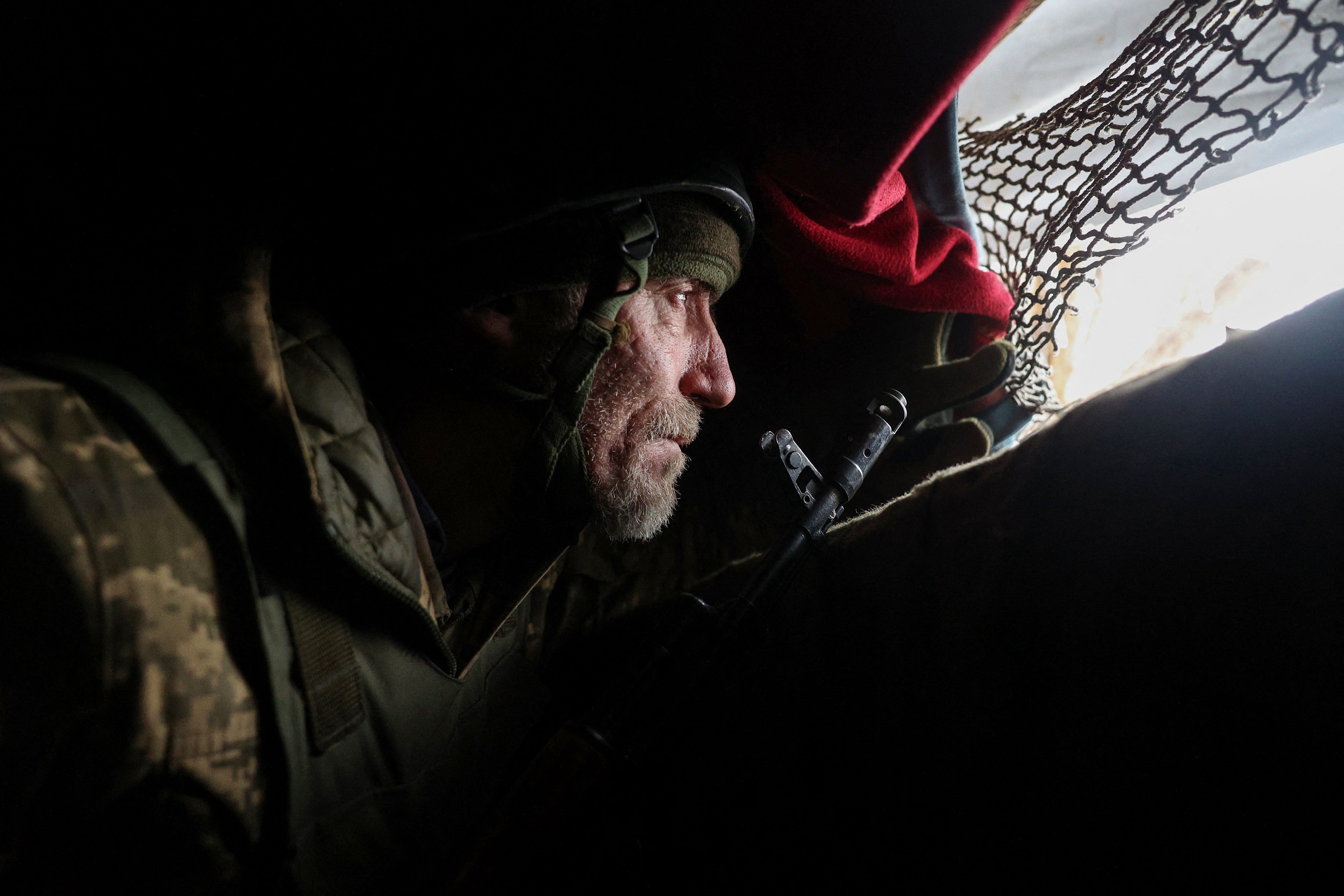 A Ukrainian soldier holds his position at the front line near a Russian-occupied Ukrainian city in the Donetsk region