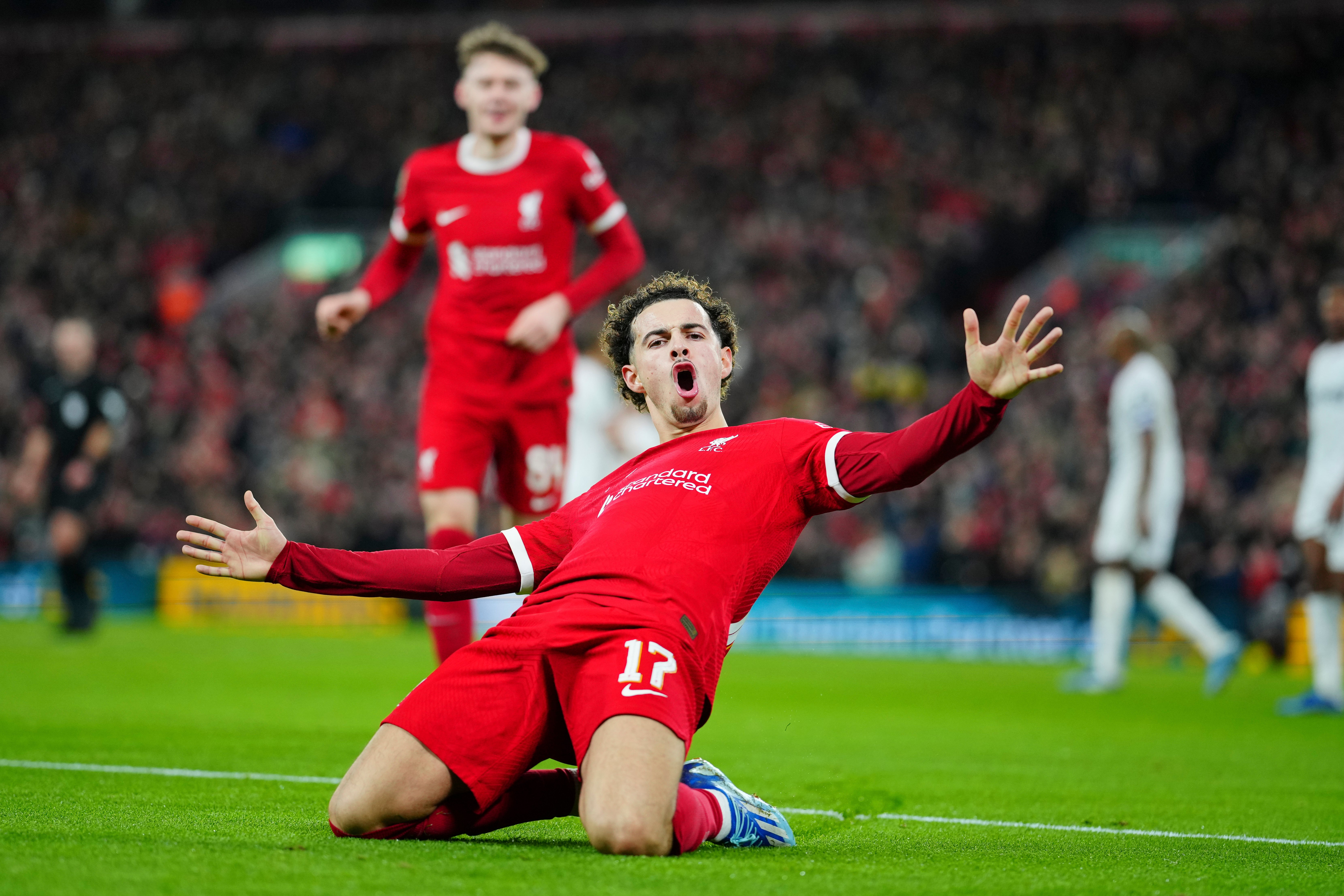 Curtis Jones slides to celebrate after scoring his goal