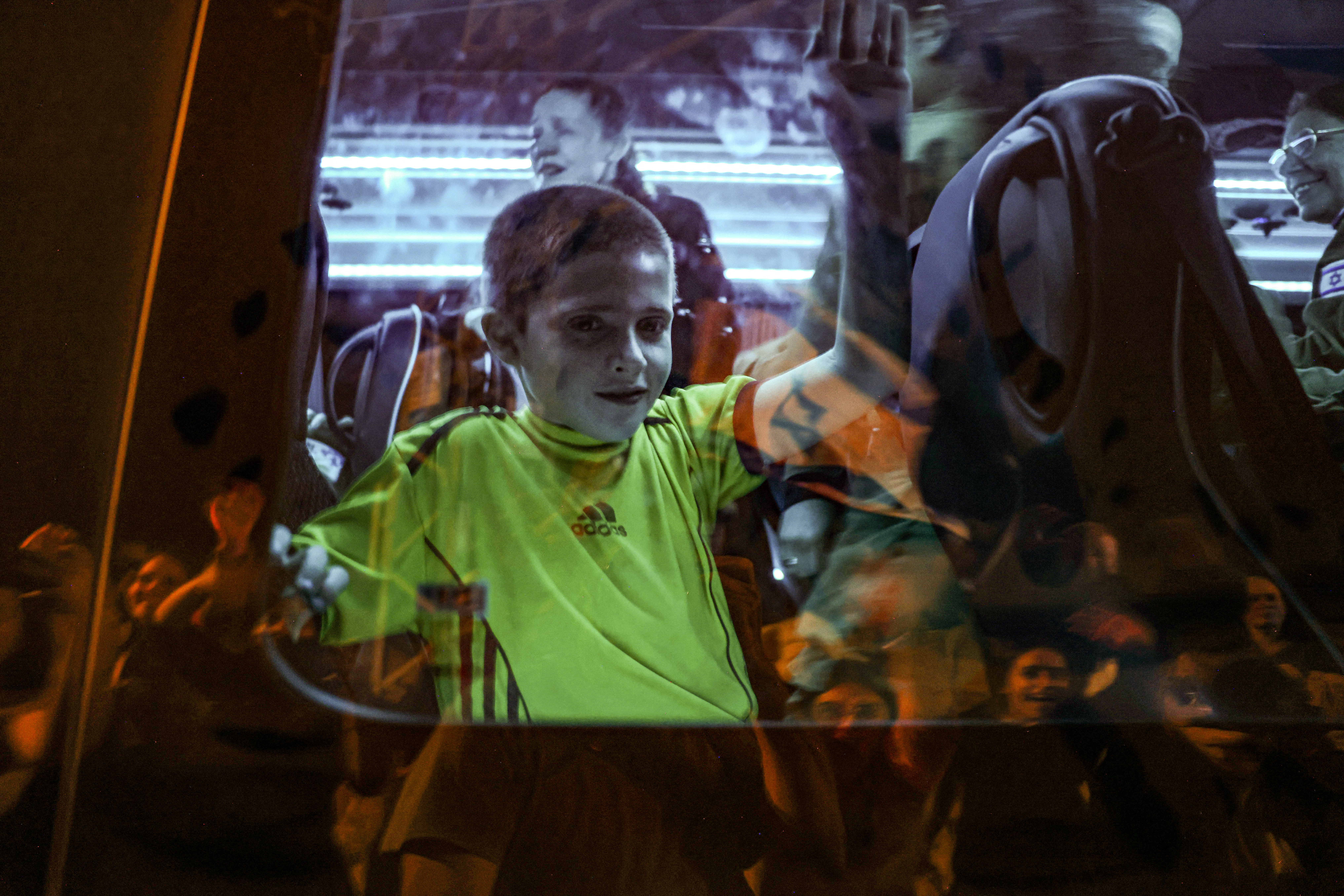 Tal Almog-Goldstein stands in a bus transporting him to an army base in Israel after he was released by Hamas in the Gaza Strip on 26 November