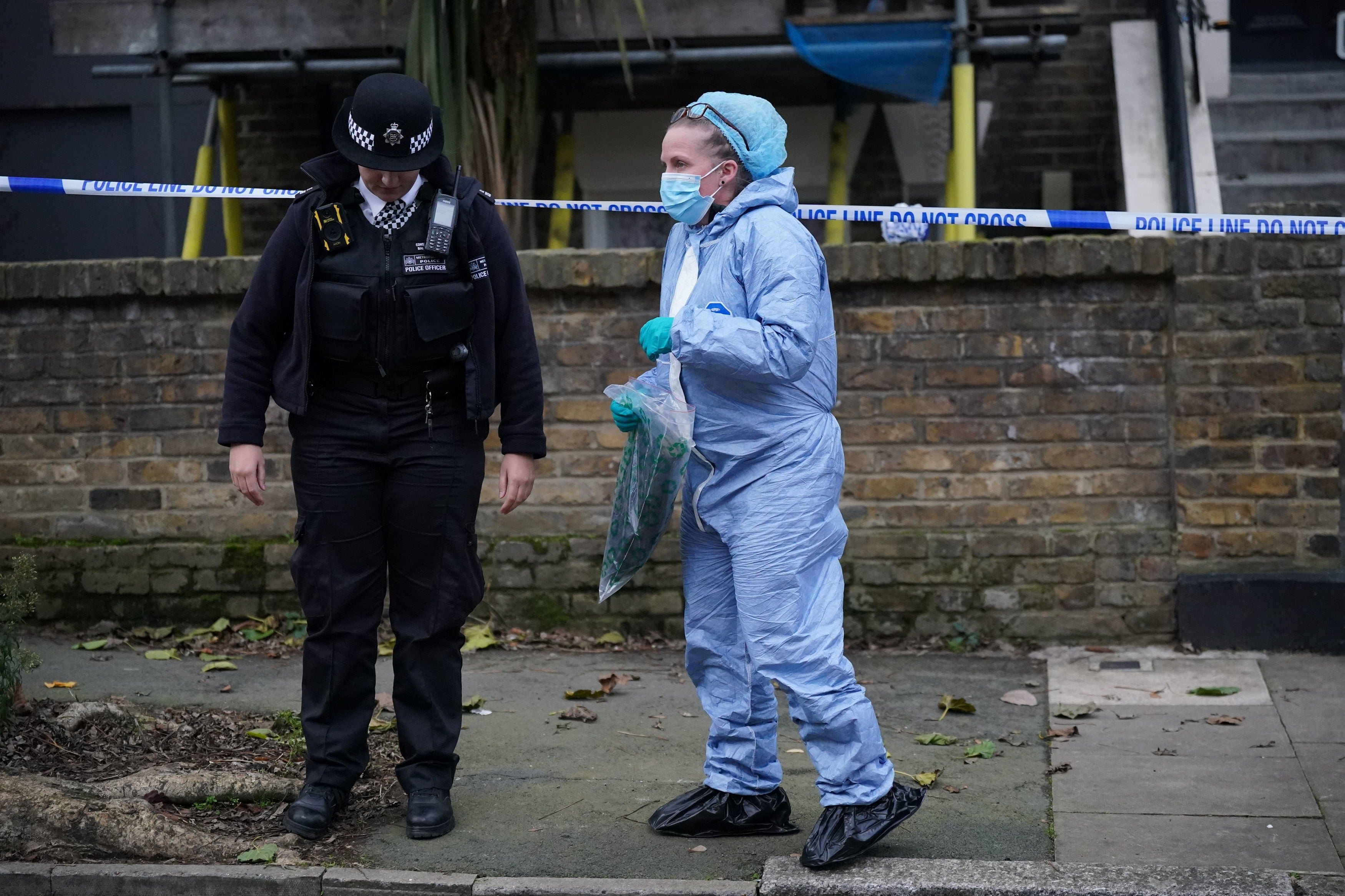 A forensic officer at the scene of the suspected murder in Montague Road in Hackney