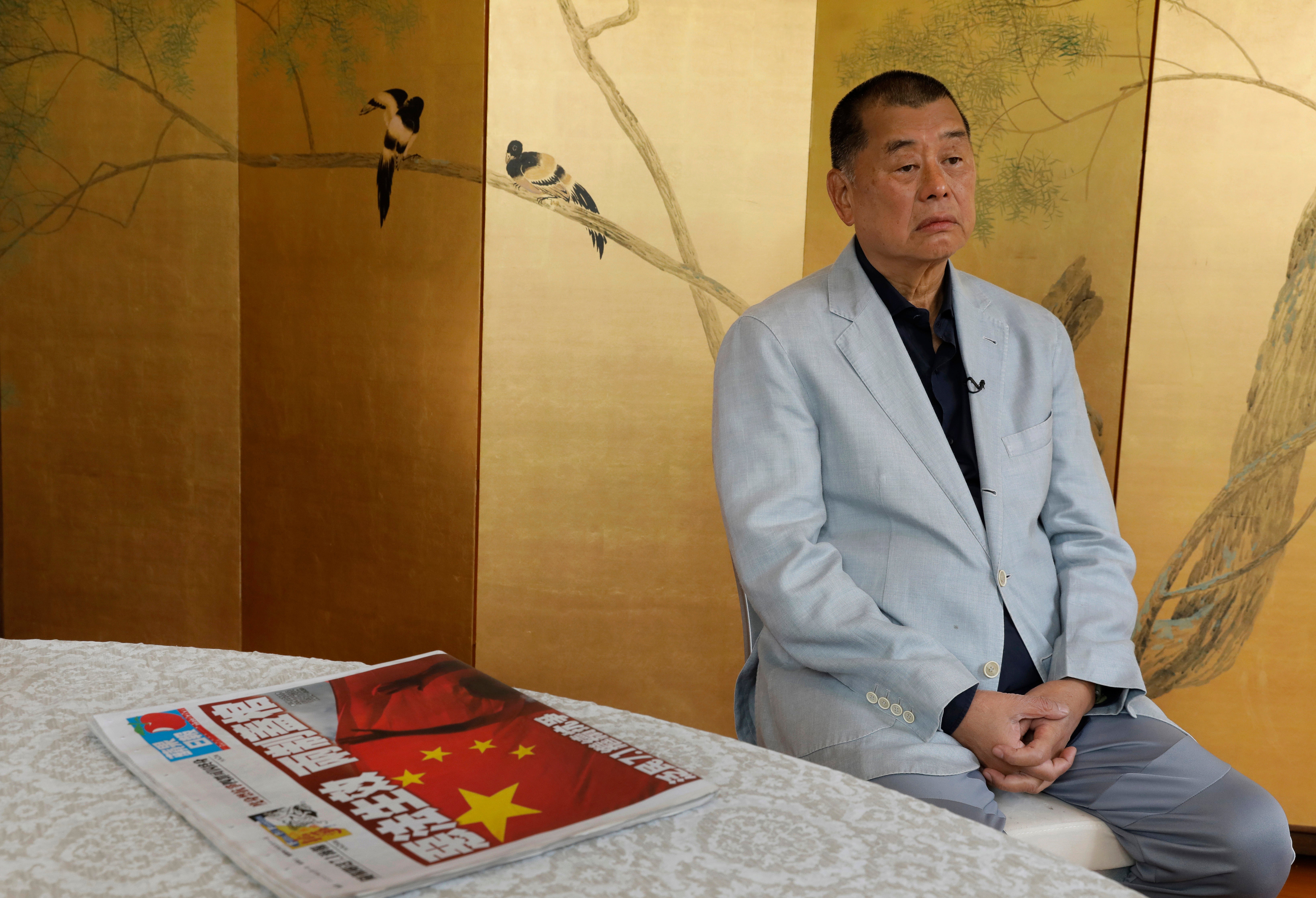 Mr Lai next to a copy of Apple Daily before his arrest