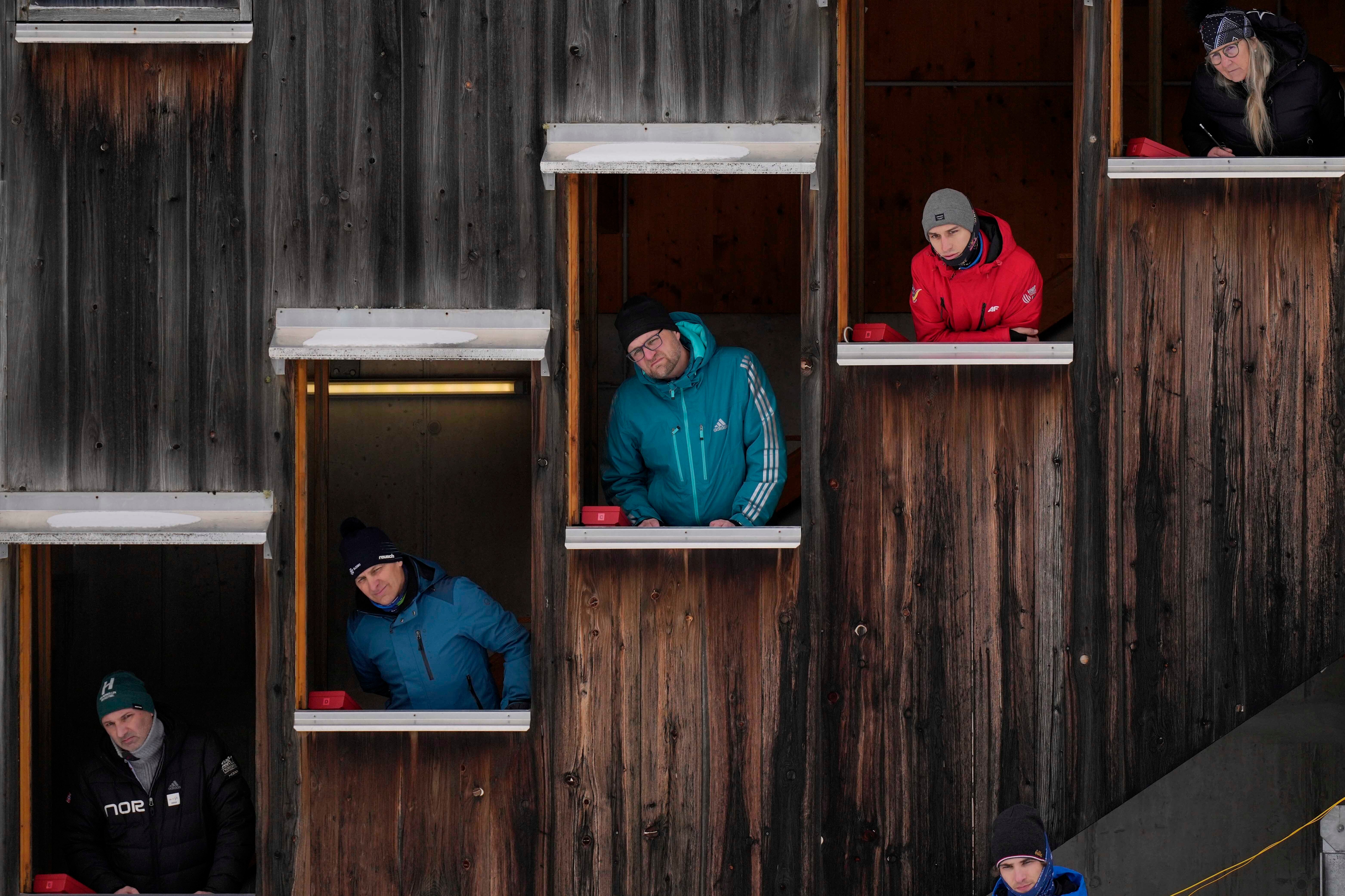 Judges watch athletes during the Nordic Combined World Cup in Ramsau, Austria