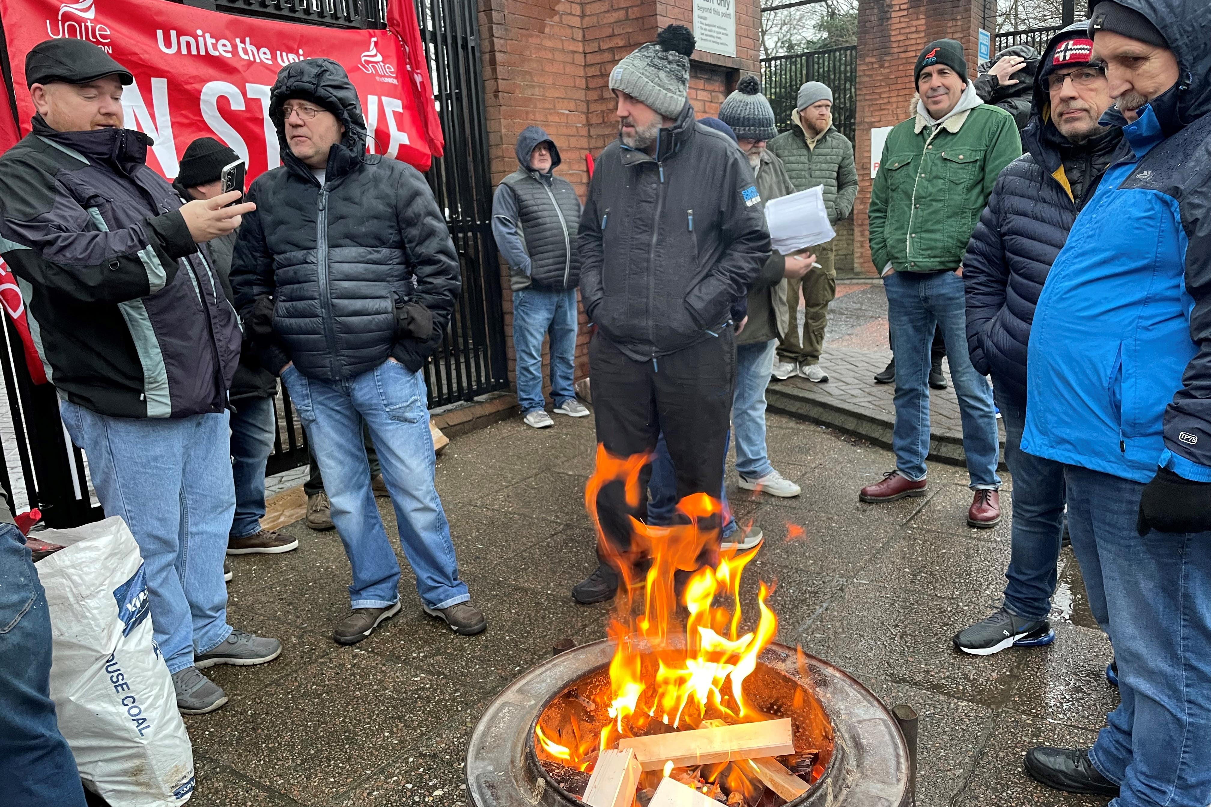 Striking workers outside the Europa Bus centre in Belfast city centre (Jonathan McCambridge/PA)