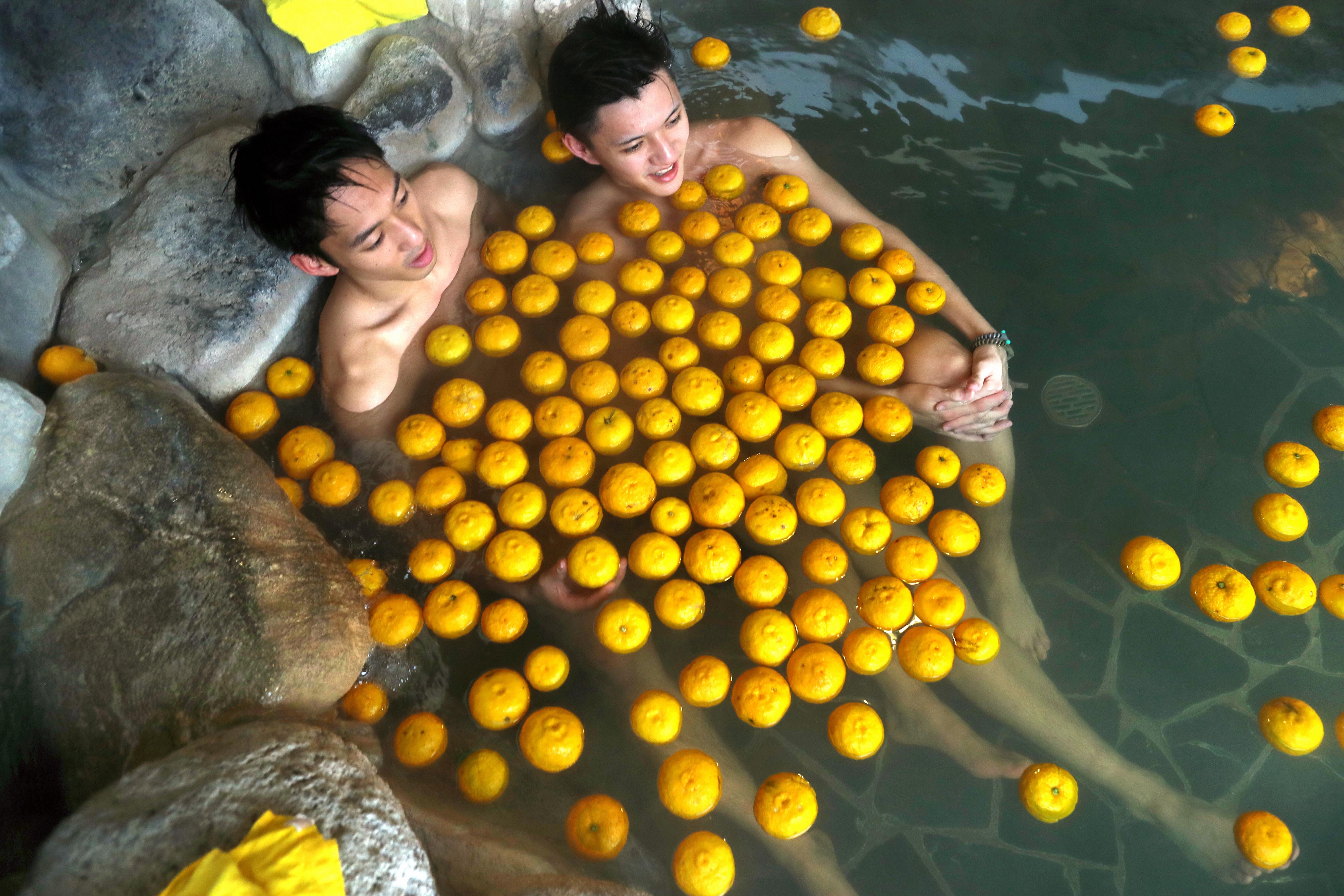 People take the yuzu bath on the winter solstice in Suita, Osaka, Japan