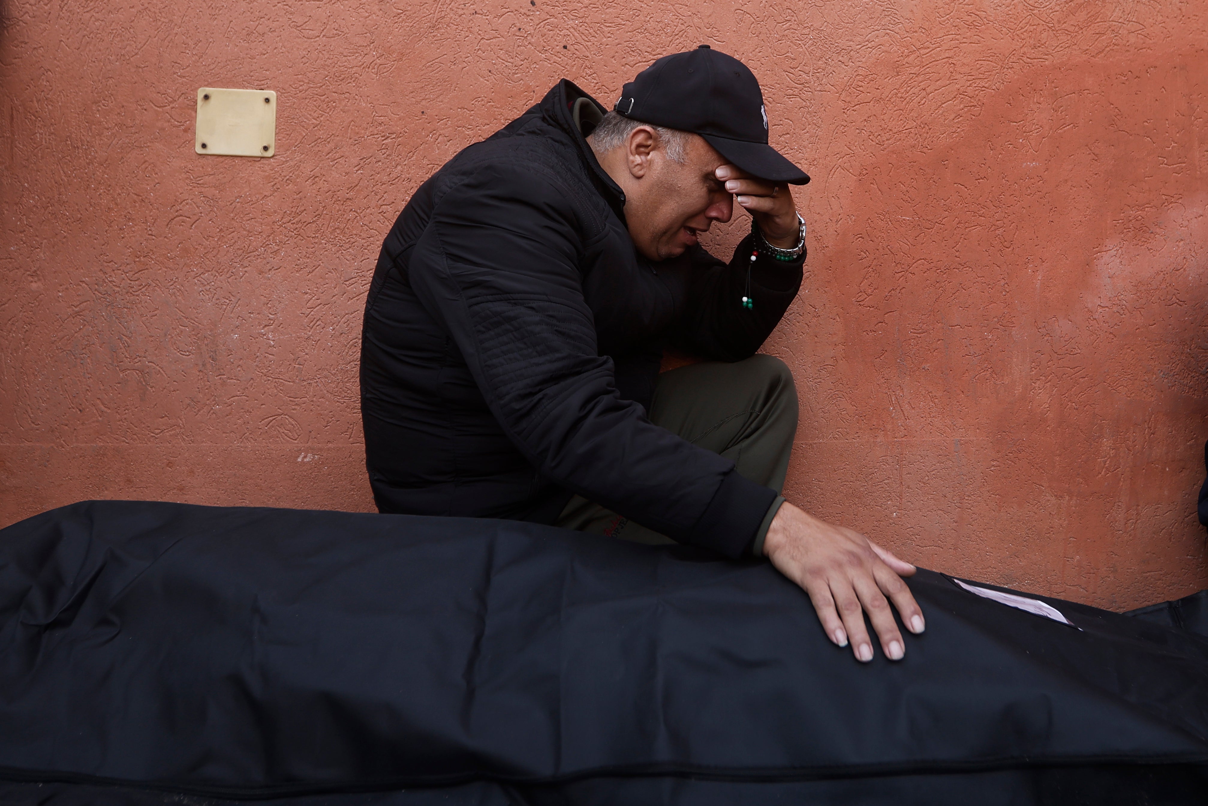 A Palestinian man cries next to his killed relative