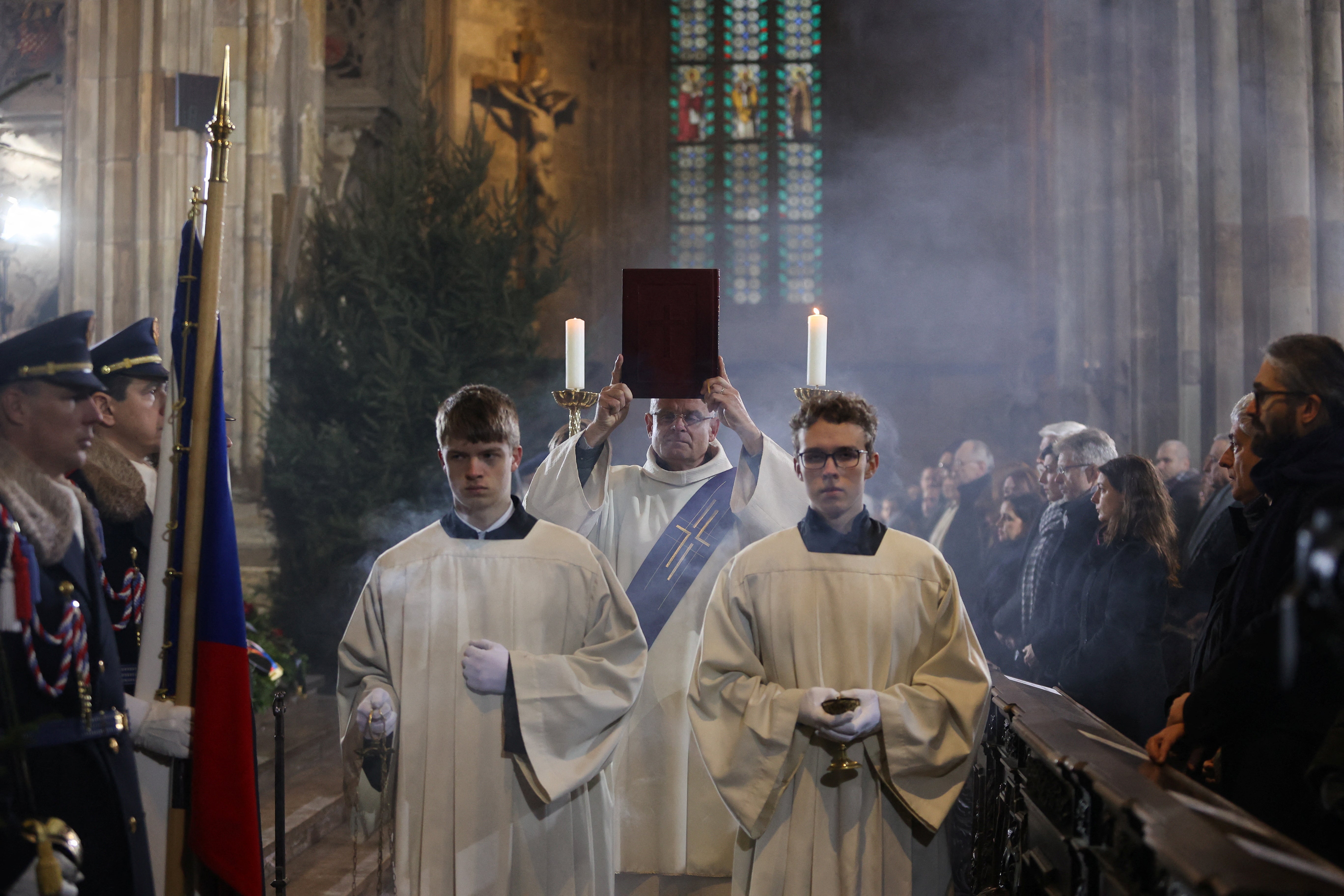 People attend a mass commemorating the victims of a shooting at one of Charles University's buildings as they observe a national mourning day at St. Vitus Cathedral in Prague, Czech Republic, on Saturday