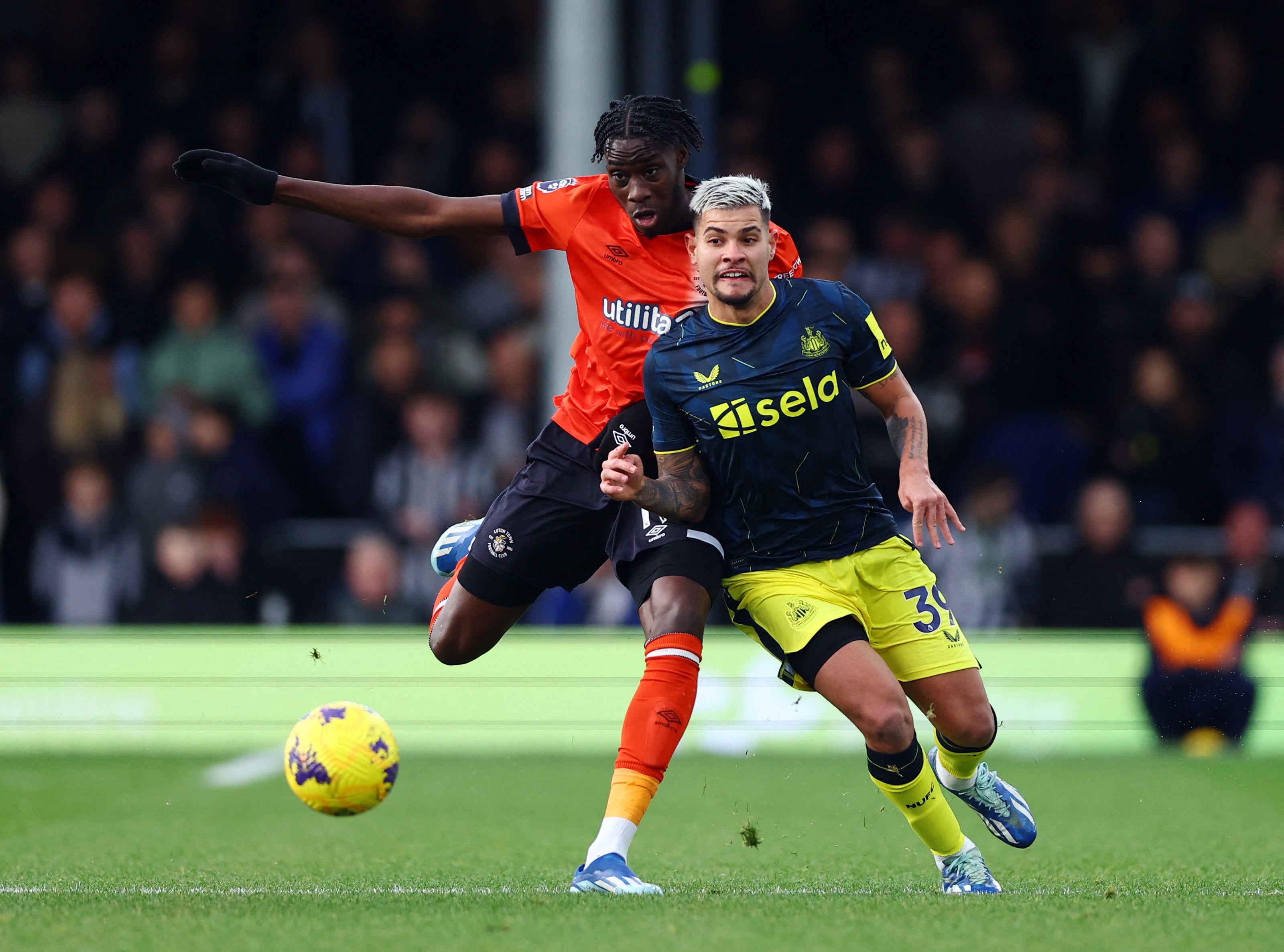 Newcastle United's Bruno Guimaraes in action with Luton Town's Elijah Adebayo