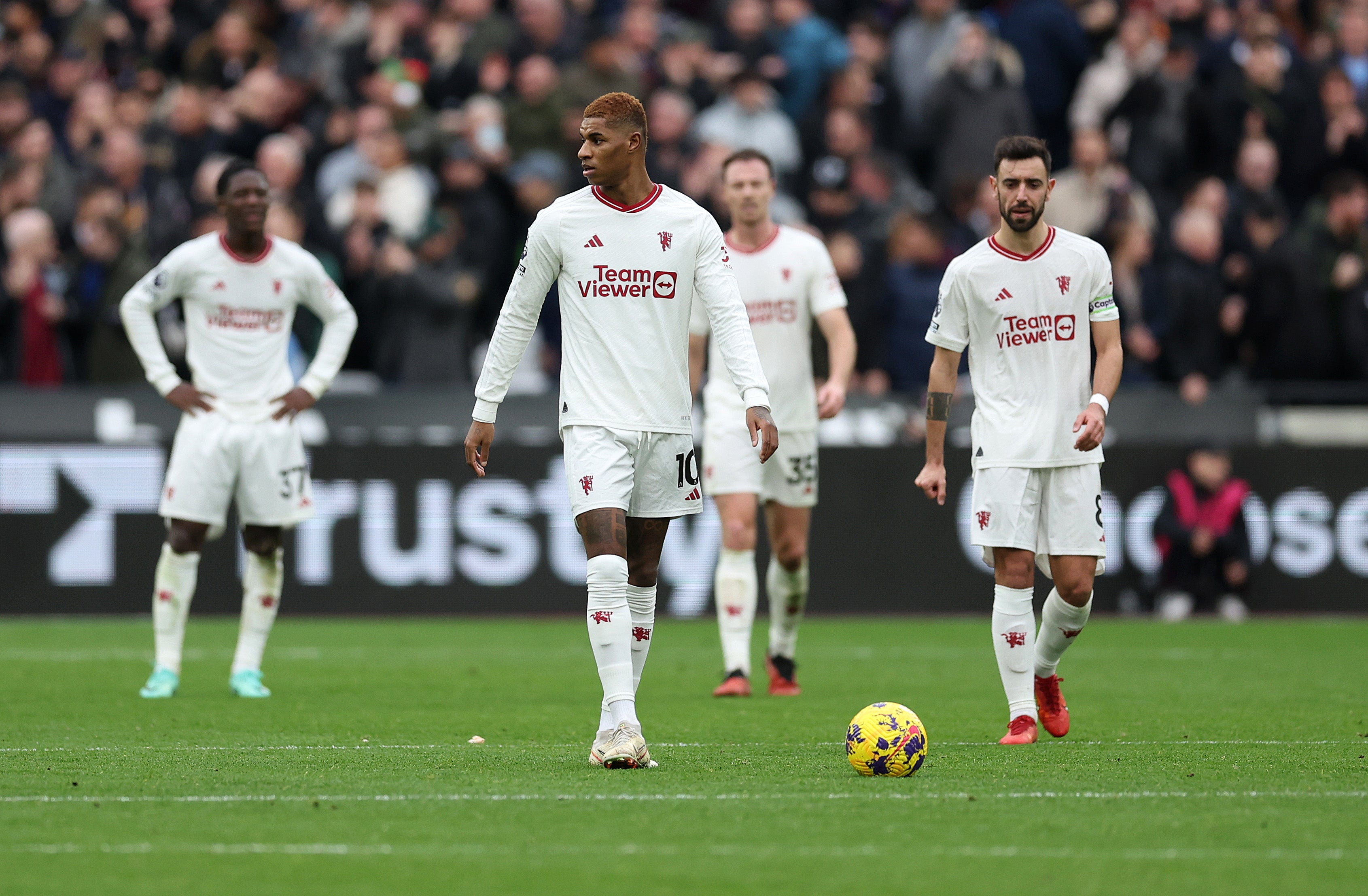 Manchester United players react following West Ham’s second goal