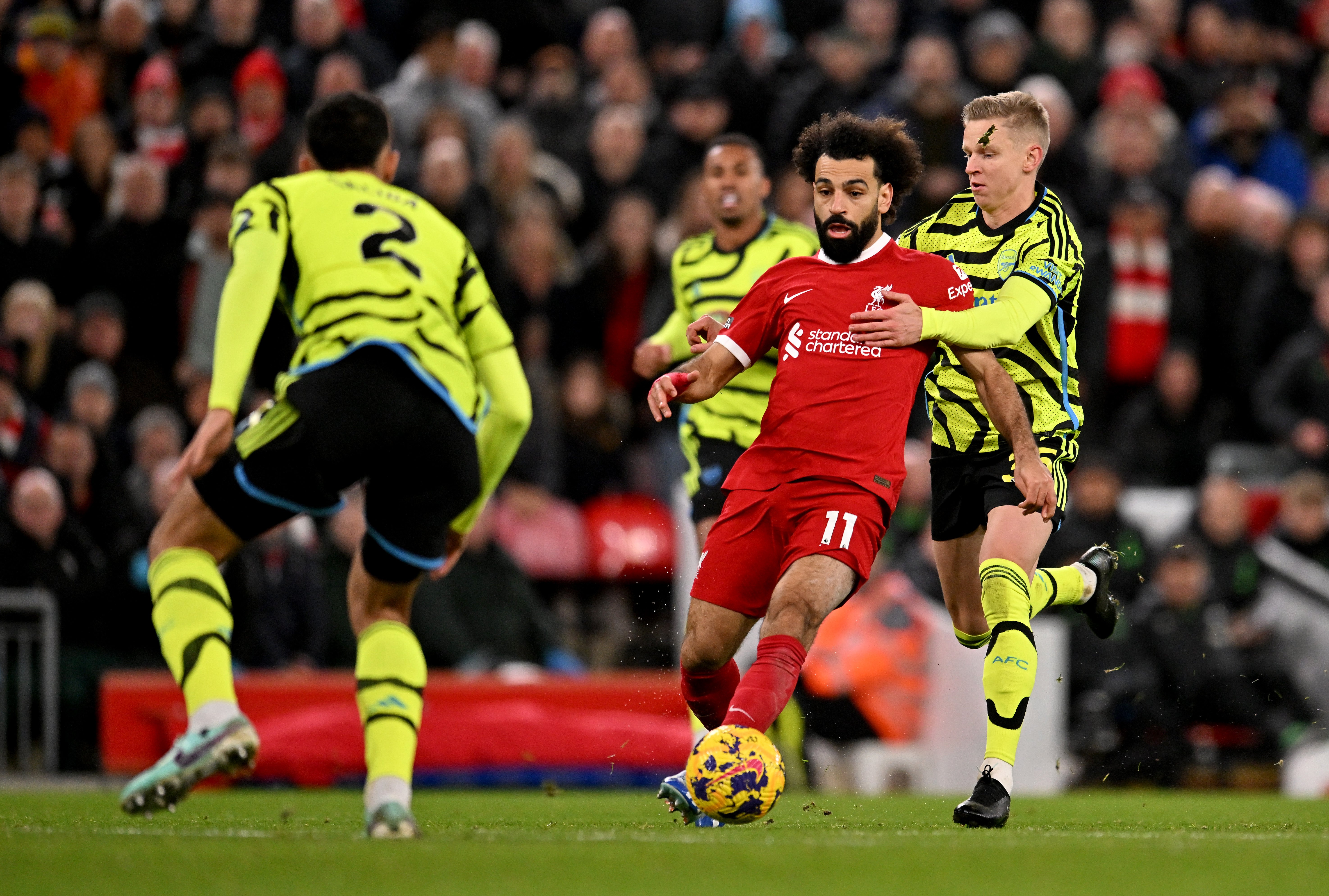 Mohamed Salah of Liverpool is pulled back by Oleksandr Zinchenko of Arsenal