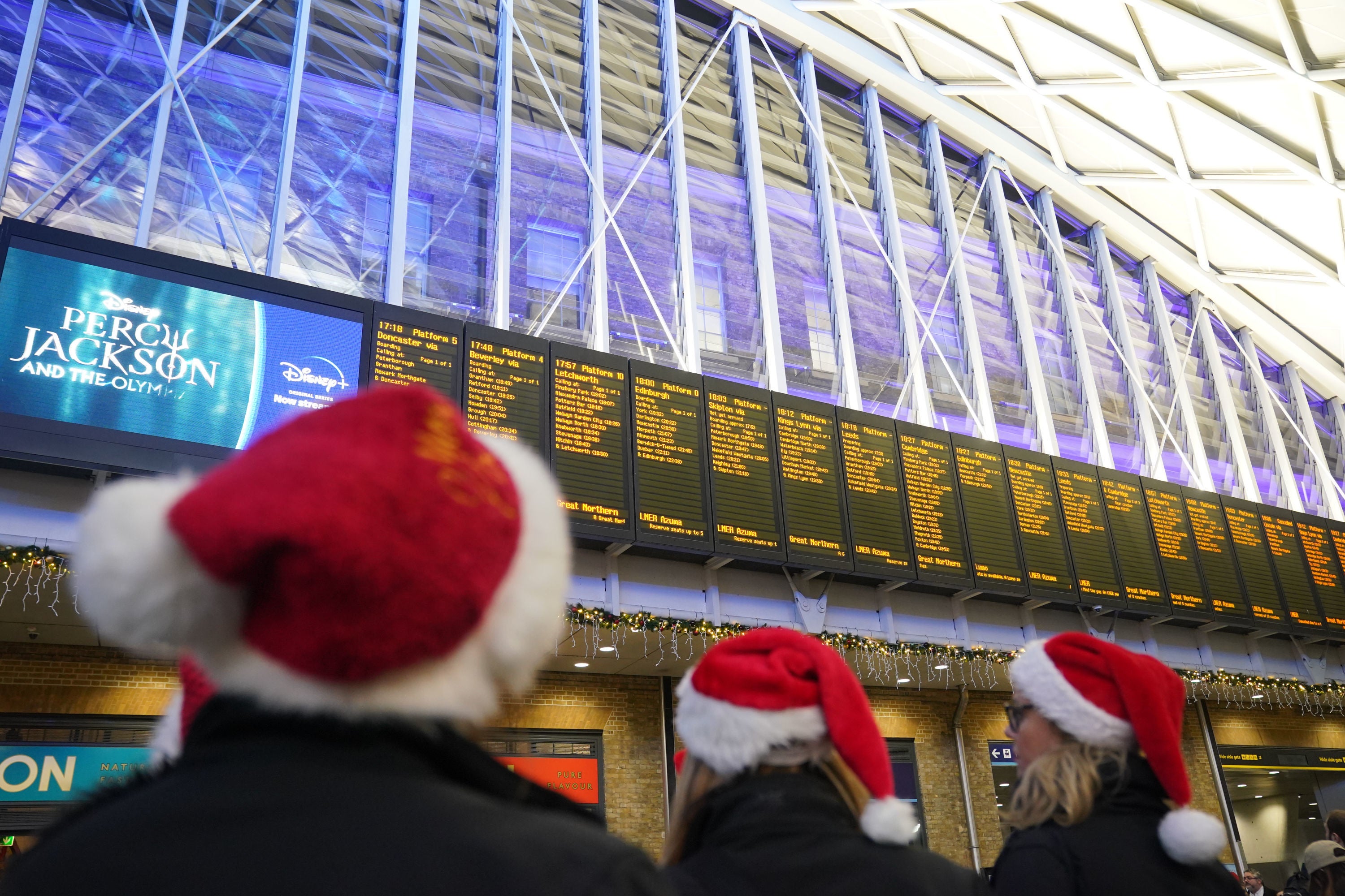 Passengers looking at departure boards at Kings Cross station, London, which is now completely closed for engineering work