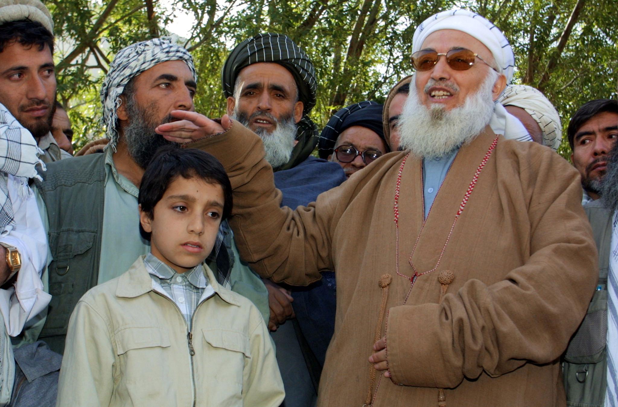A 12-year-old Ahmad Massoud, the son of dead commander Ahmad Shah Massoud, being comforted by the then Afghan president at a funeral ceremony after his father’s death in an al-Qaeda attack