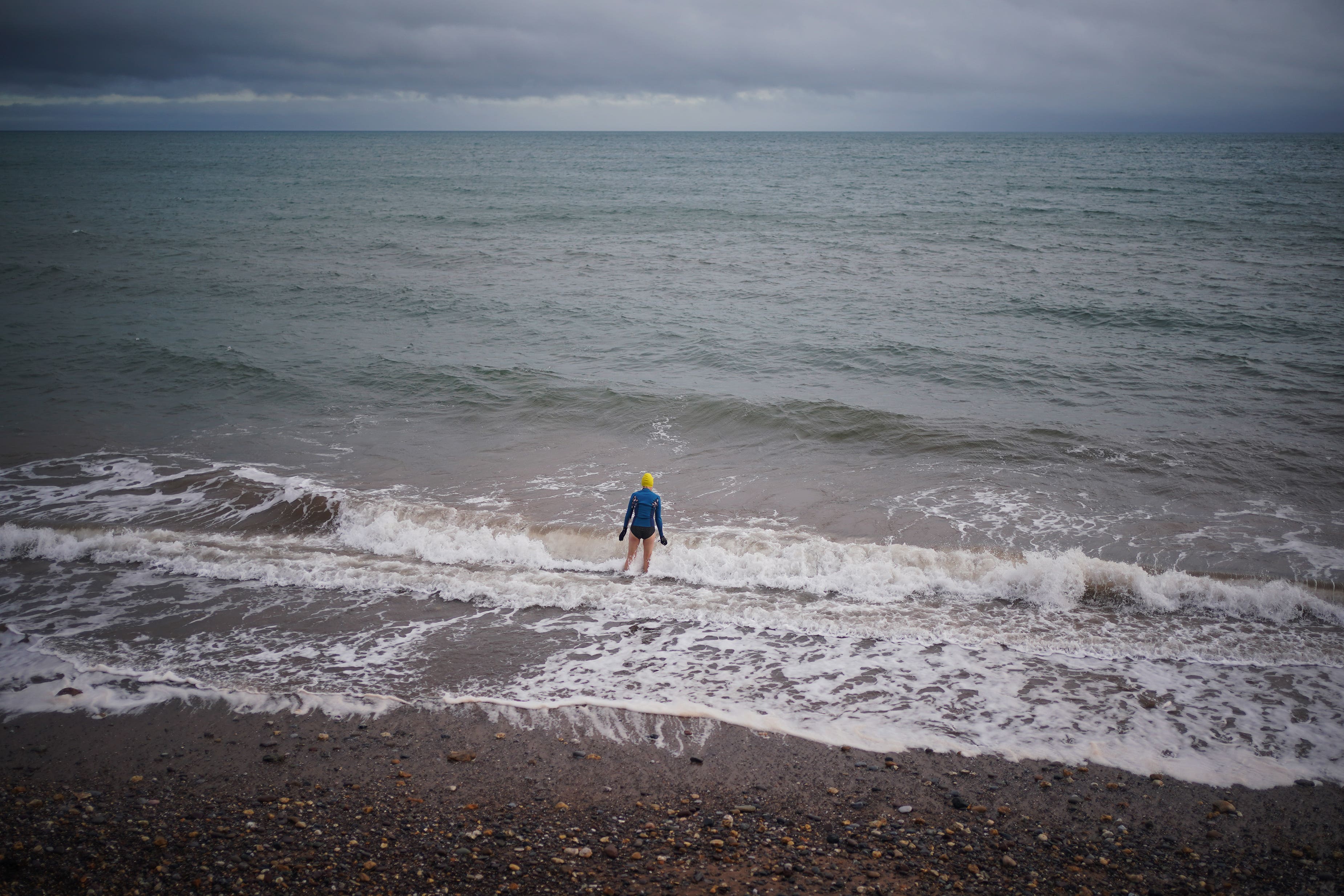 A swimmer in the sea in Dawlish Warren, south Devon on Christmas Eve (Yui Mok/PA)