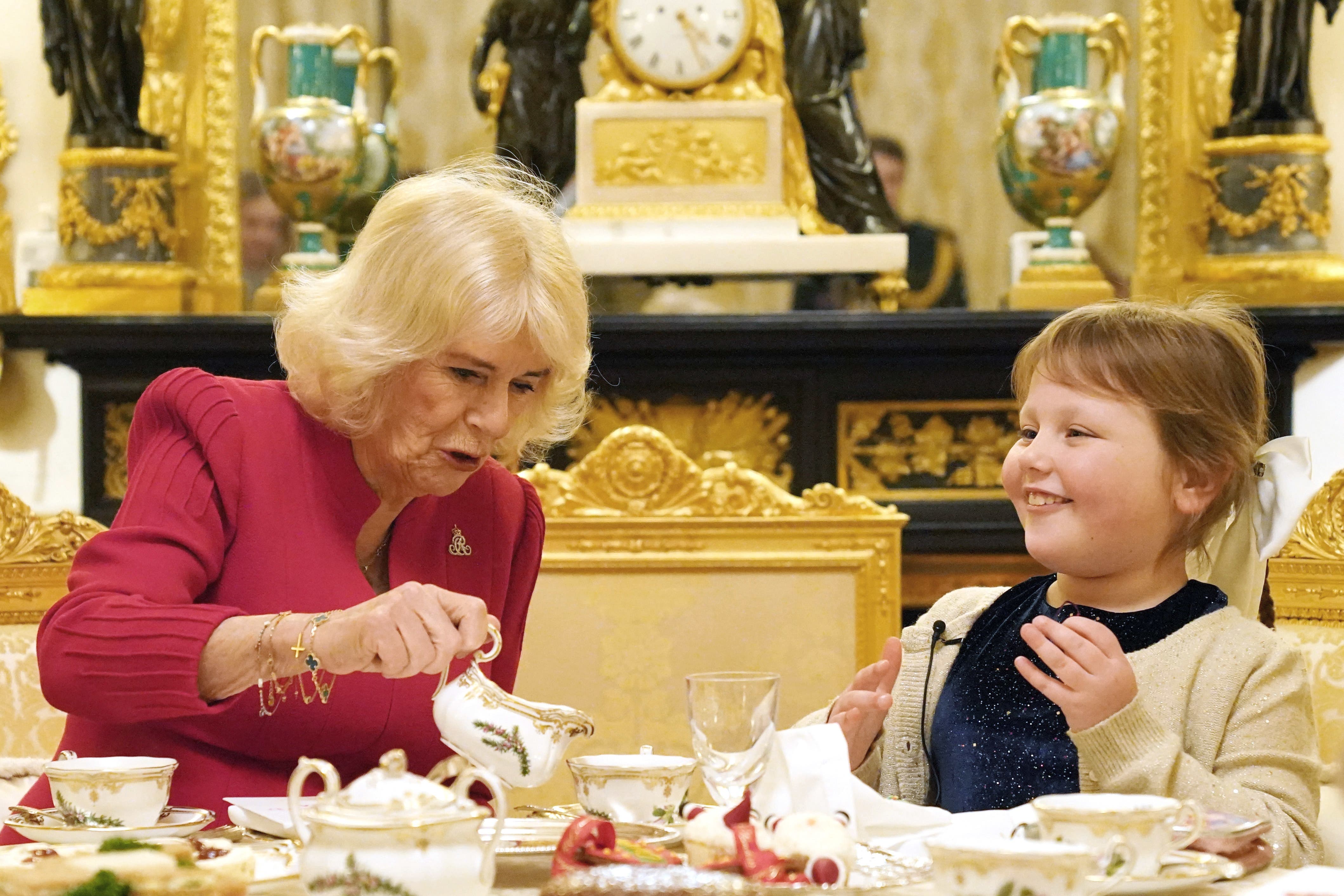 The Queen drinks tea with seven-year-old Olivia Taylor (Jonathan Brady/PA)