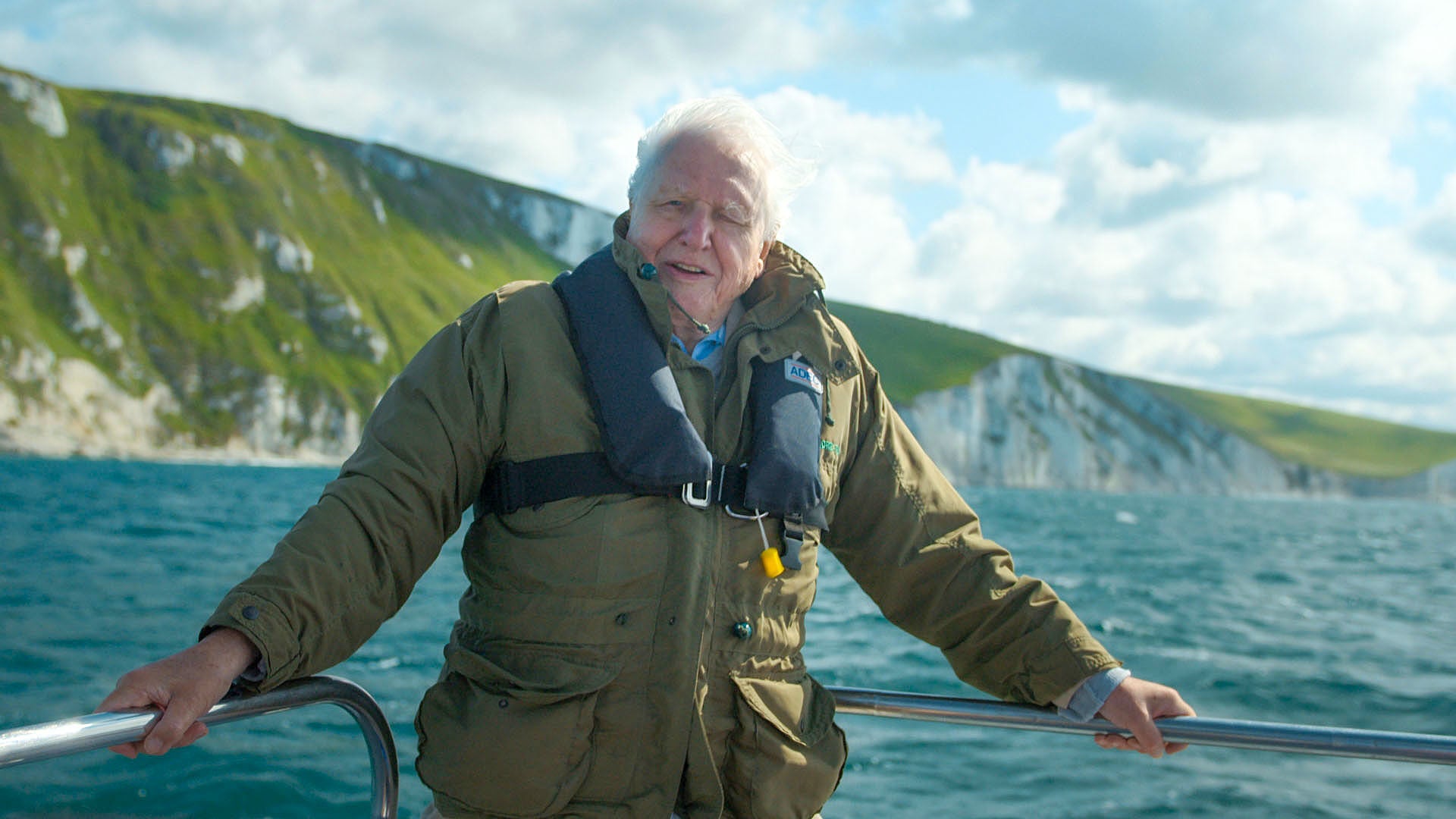 Sir David Attenborough onboard a boat while filming near White Nothe cliffs, on the Jurassic Coast, Dorset.