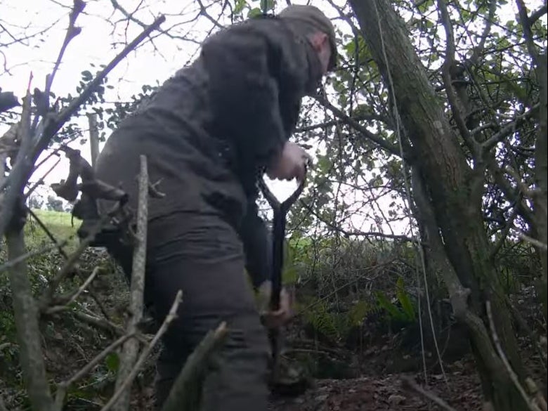 The two terriermen appeared to fill badger sett entrances with earth