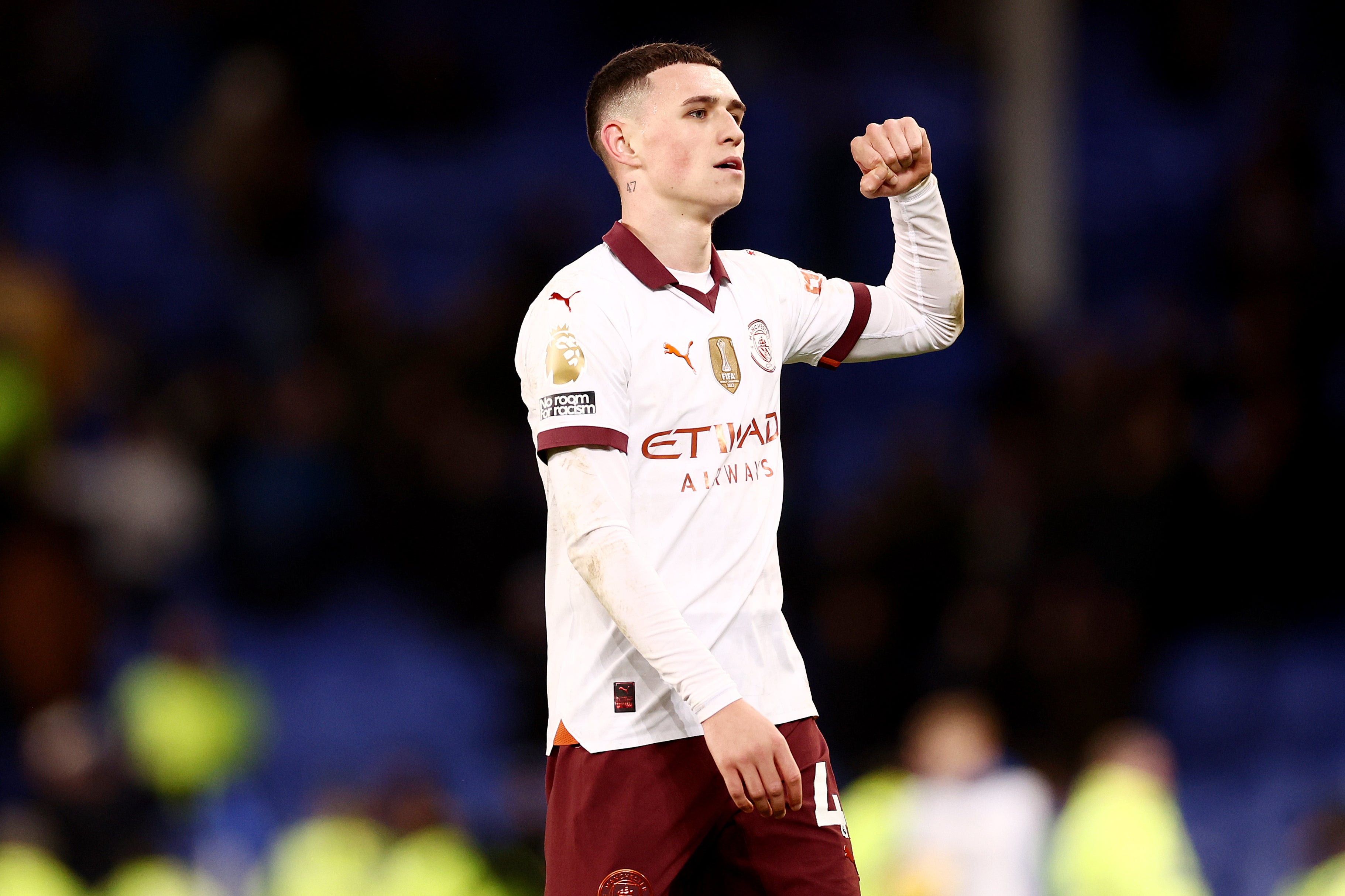 Phil Foden celebrates after the full-time whistle at Everton