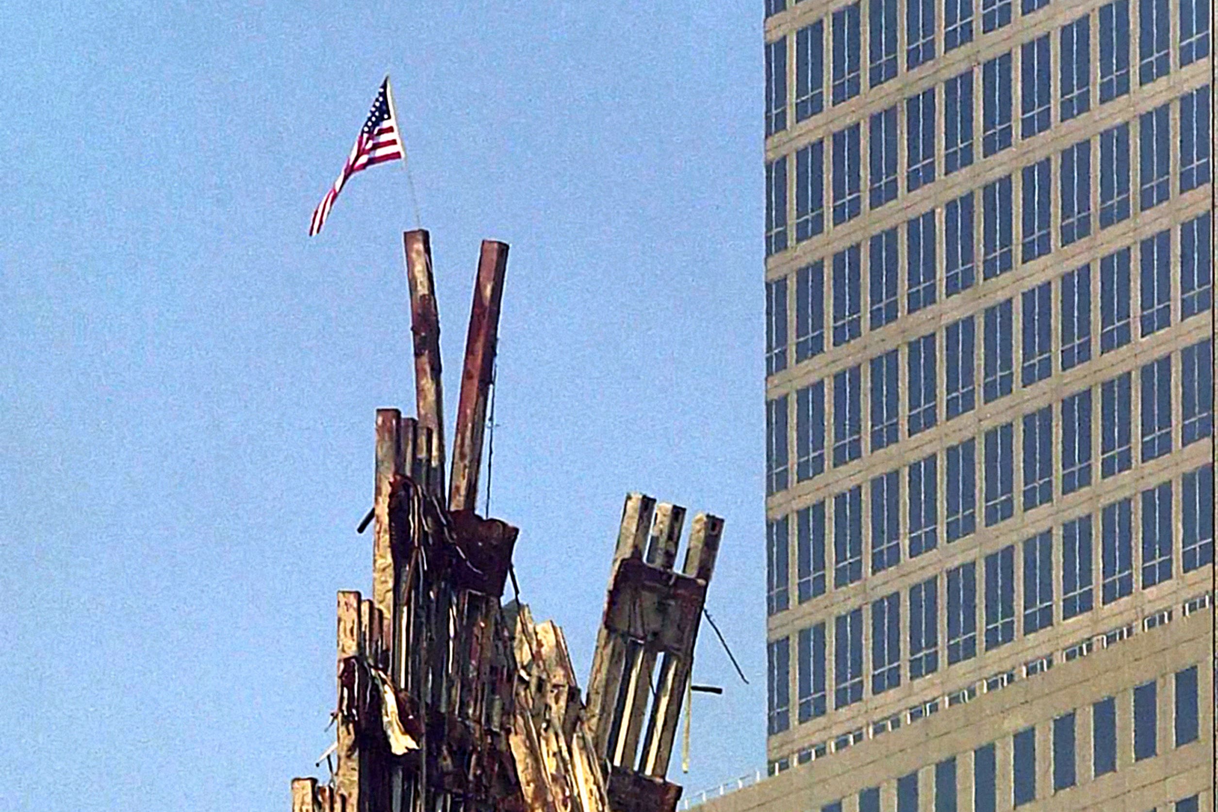 A US flag flies from the remains of the World Trade Centre (PA)