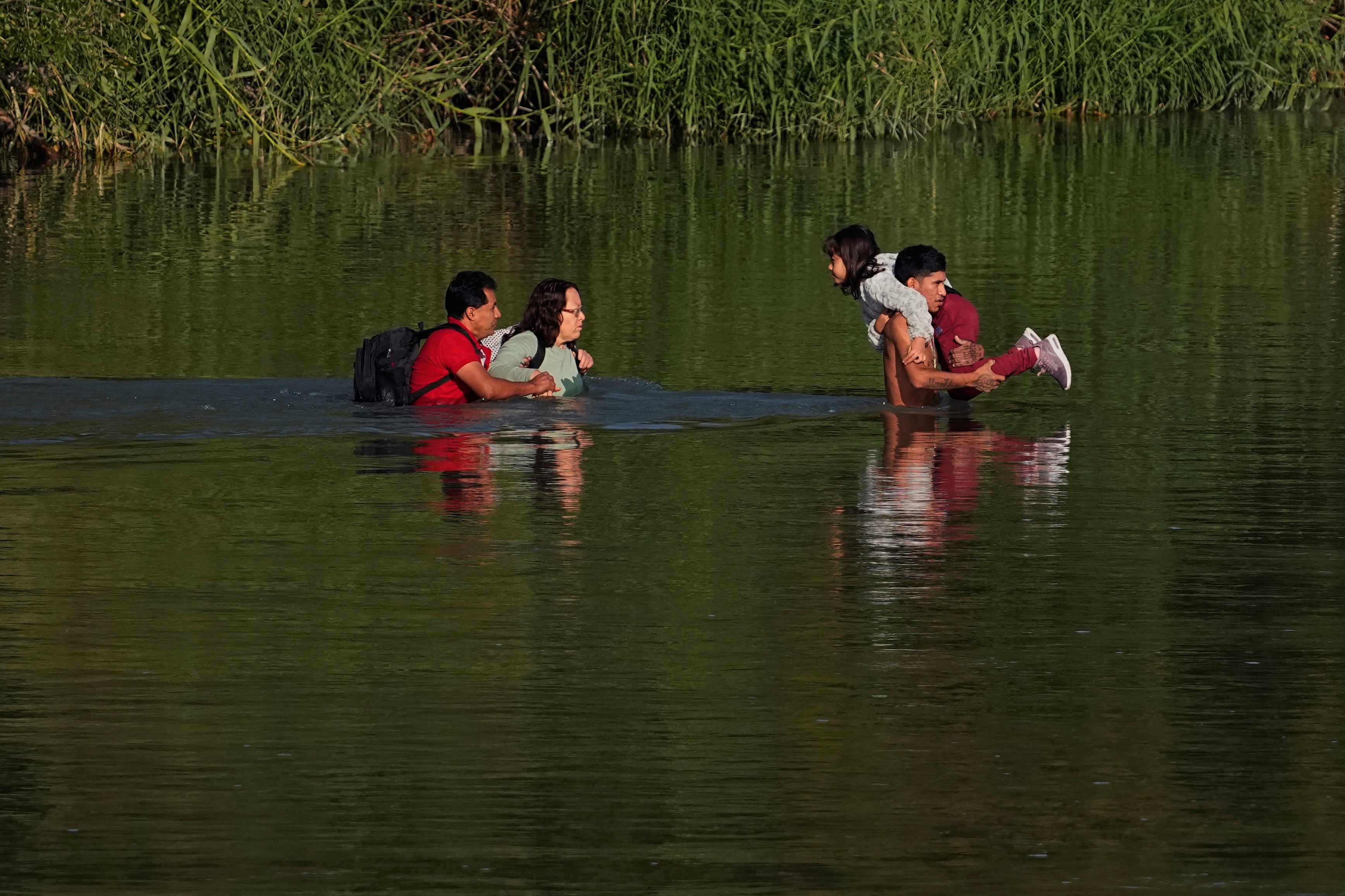 Migrants cross the Rio Grande and entered the US from Mexico on 19 October 2023 in Eagle Pass, Texas