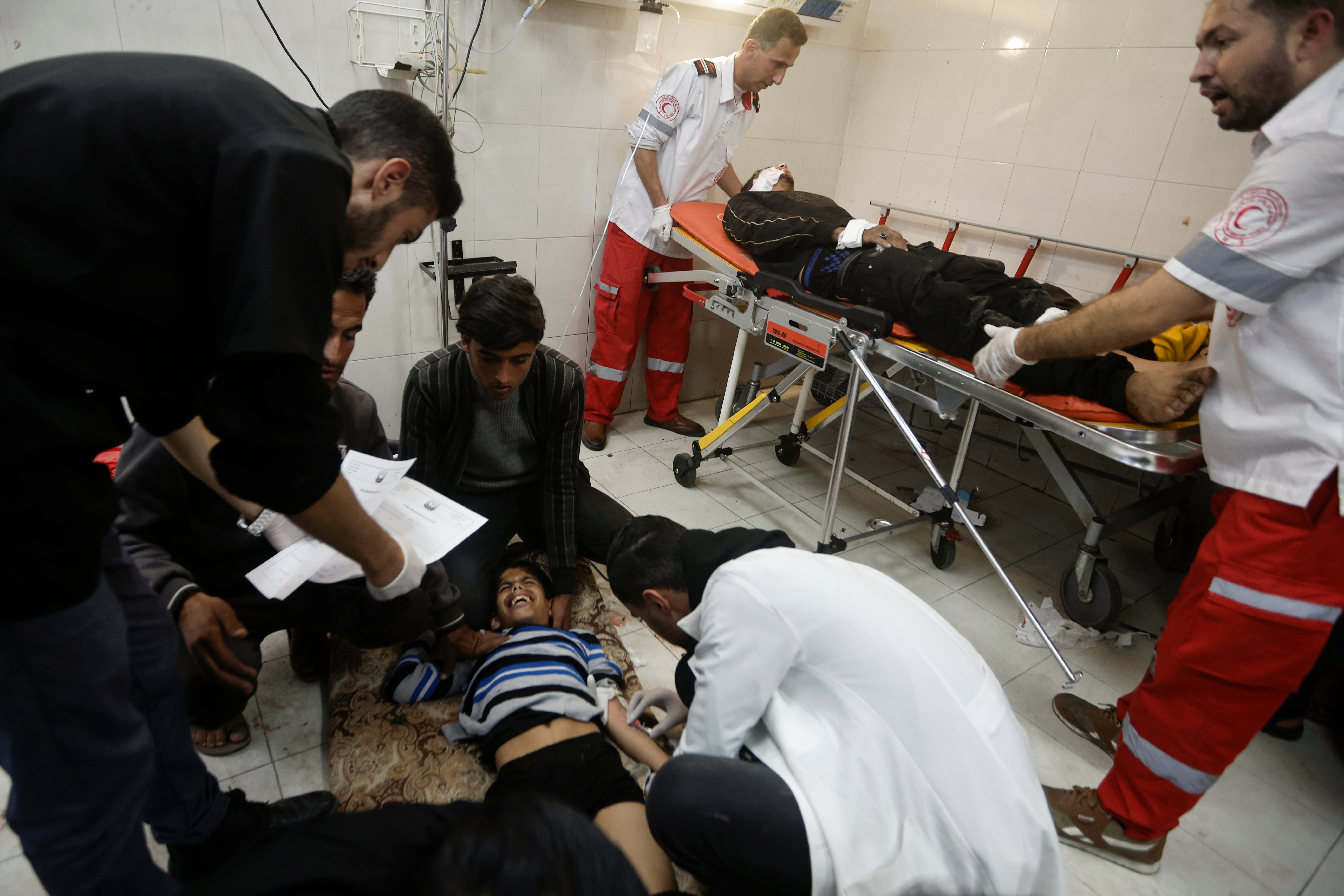 A wounded child is among those to receive treatment in hospital in Khan Younis, Gaza