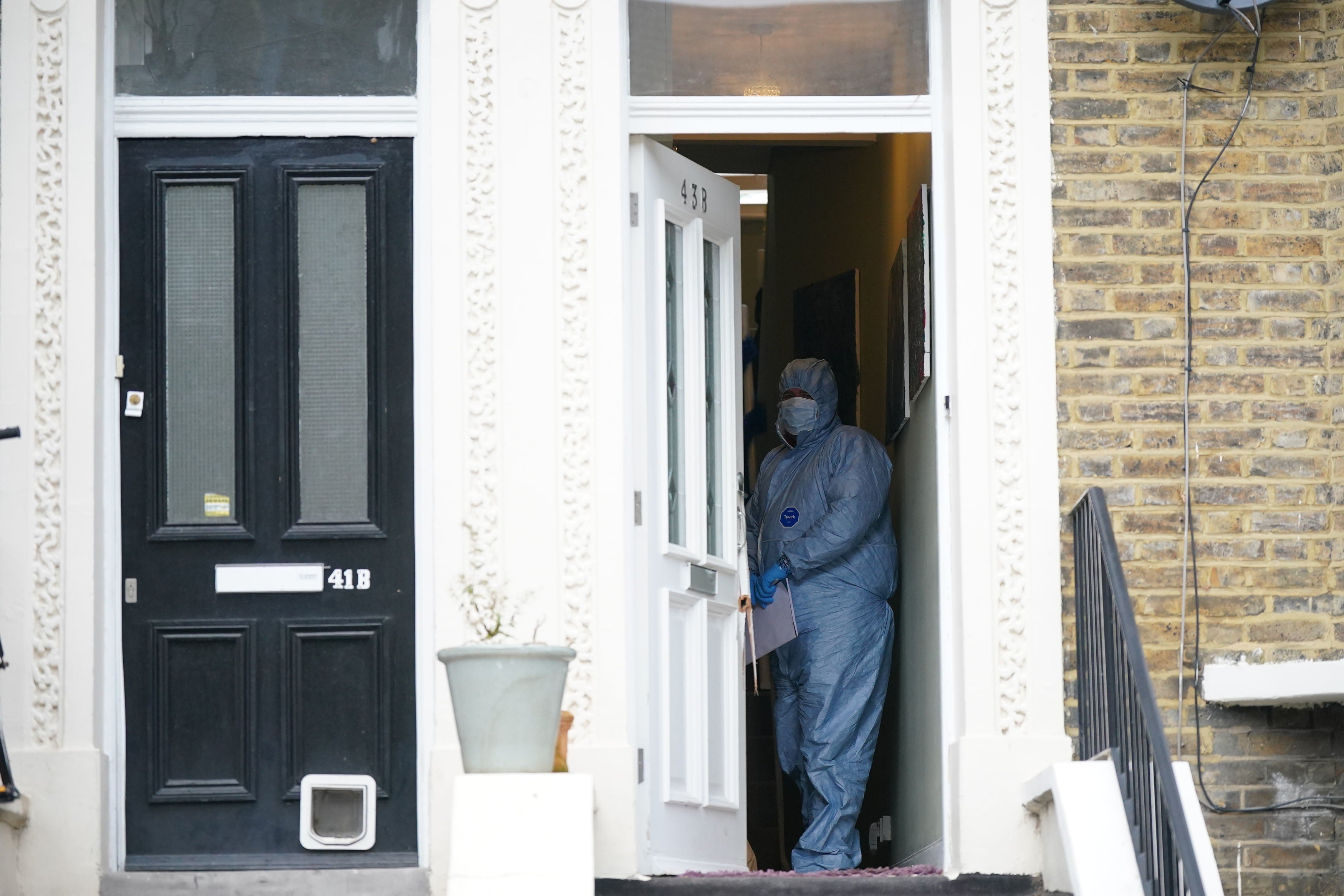 Forensic officers at a property on Montague Road in Dalston, east London, where the four-year-old died