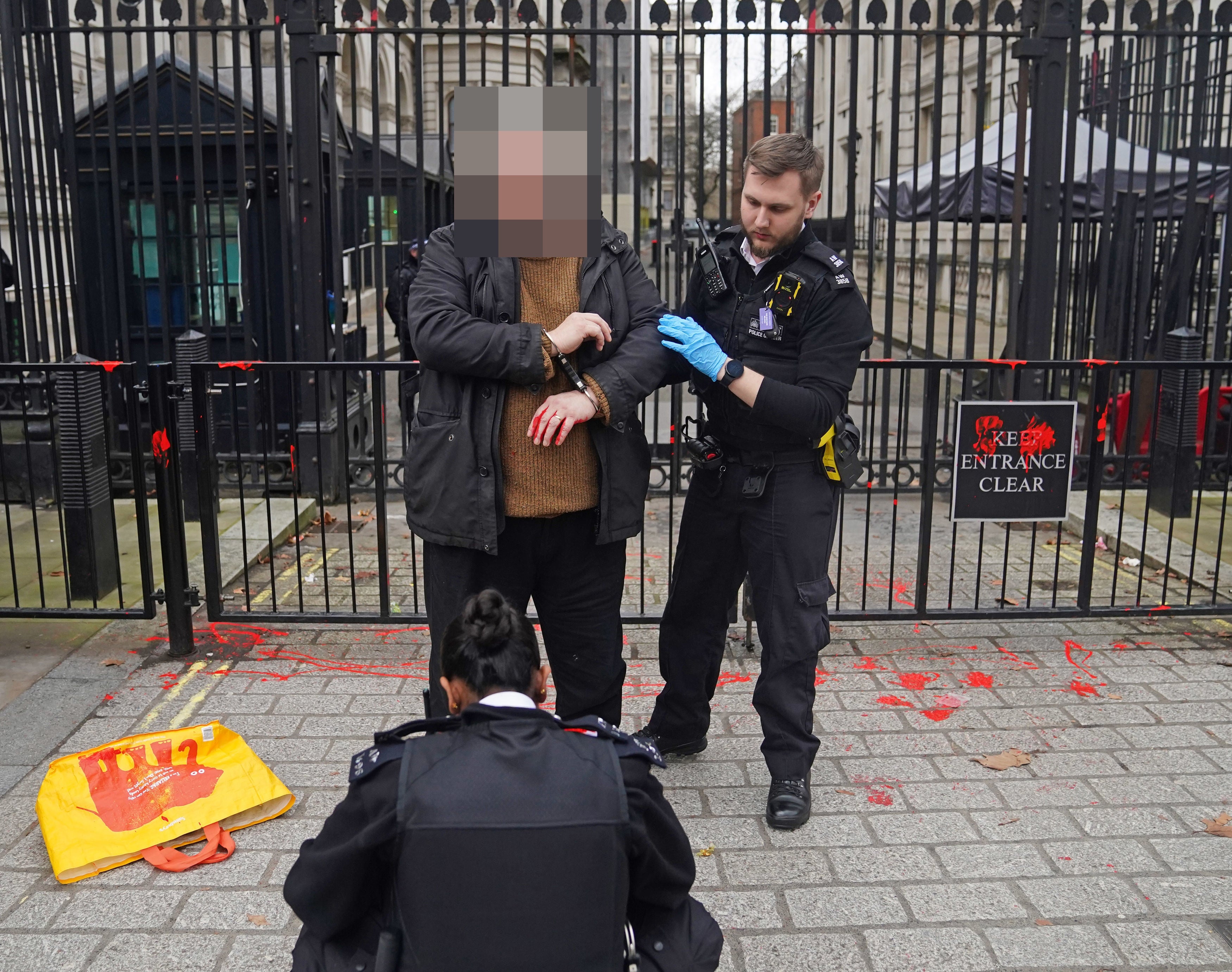 A man being arrested outside Downing Street in London