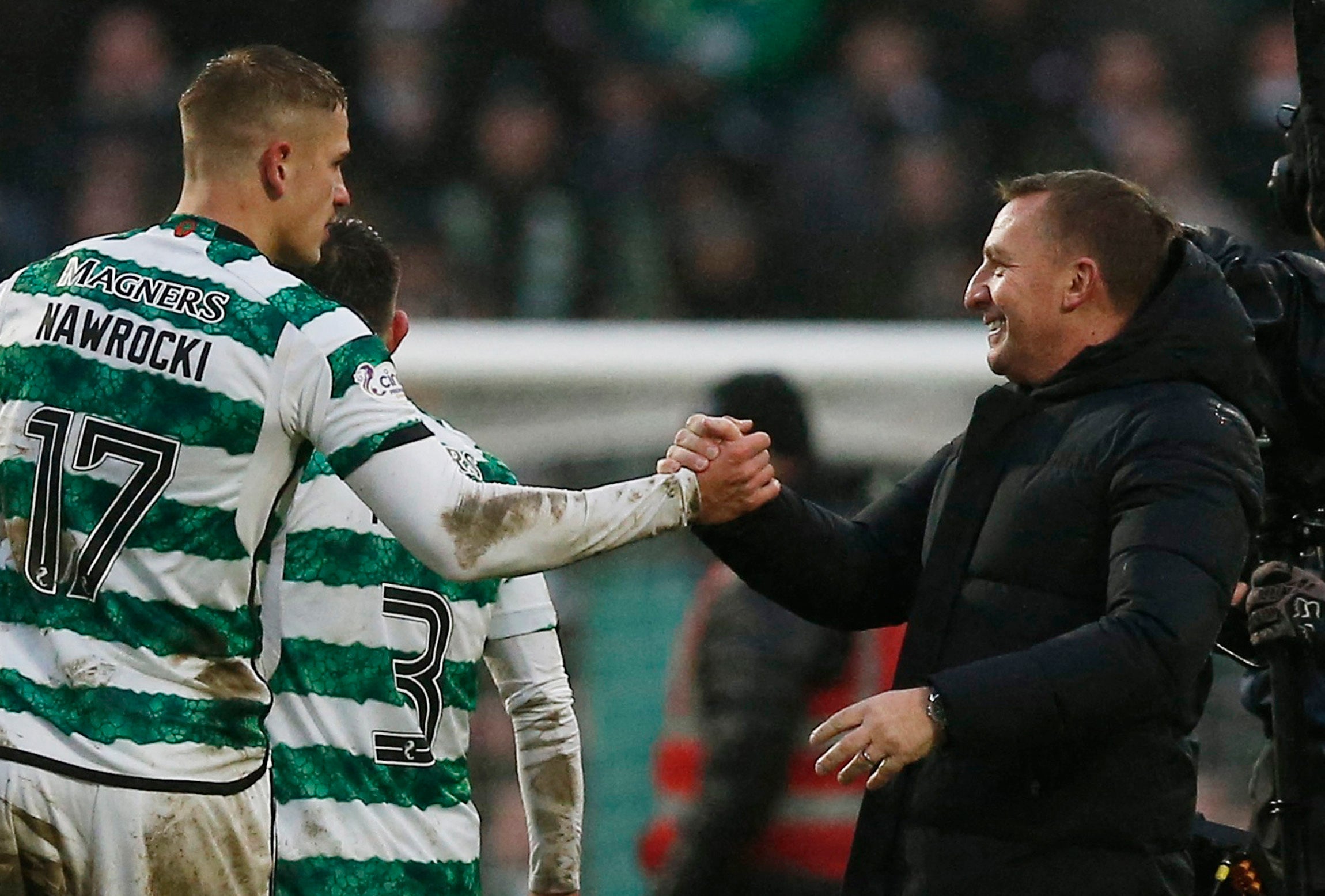 Celtic boss Brendan Rodgers congratulates substitute Maik Nawrocki at full time