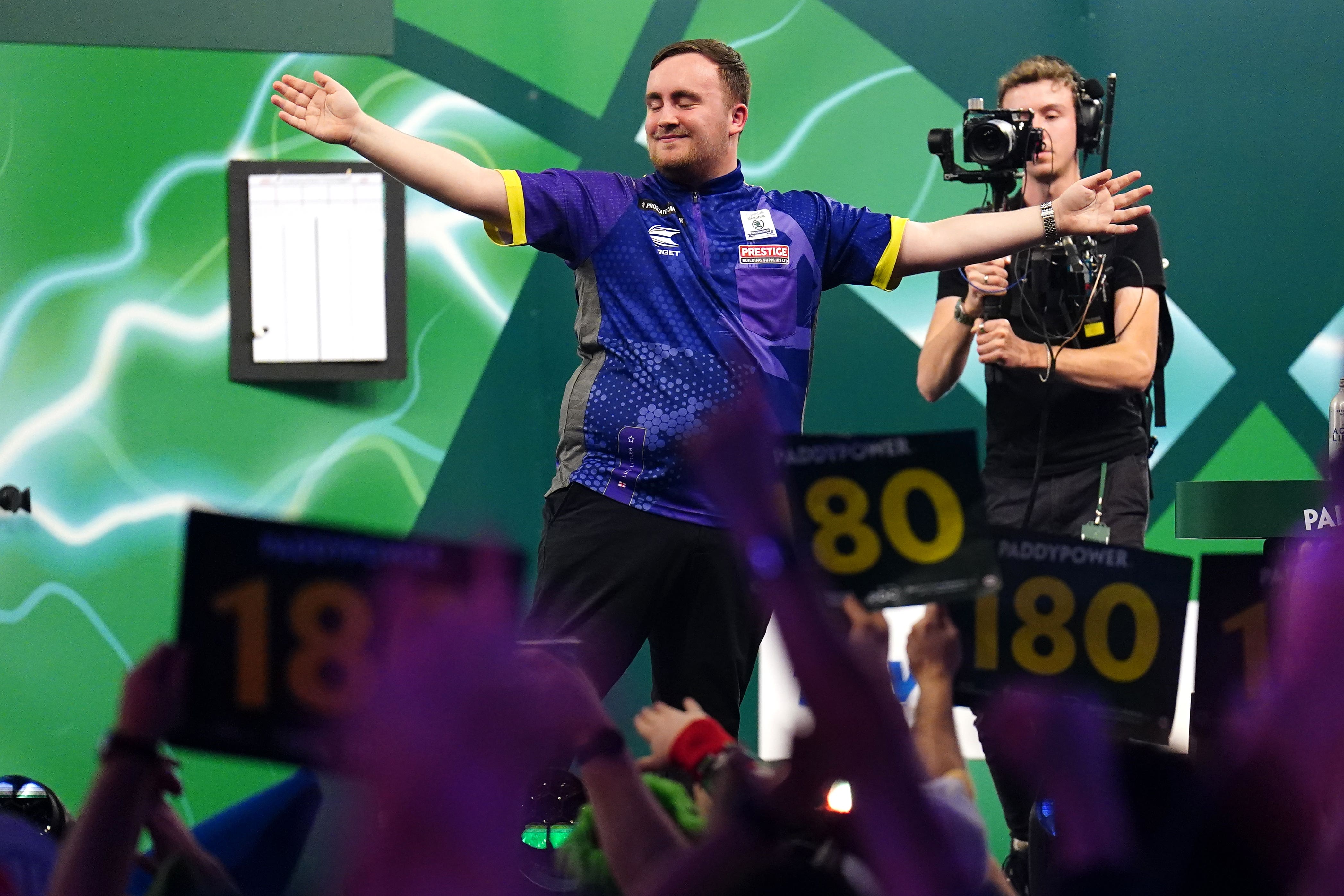 Luke Littler celebrates victory over Raymond van Barneveld (Zac Goodwin/PA)