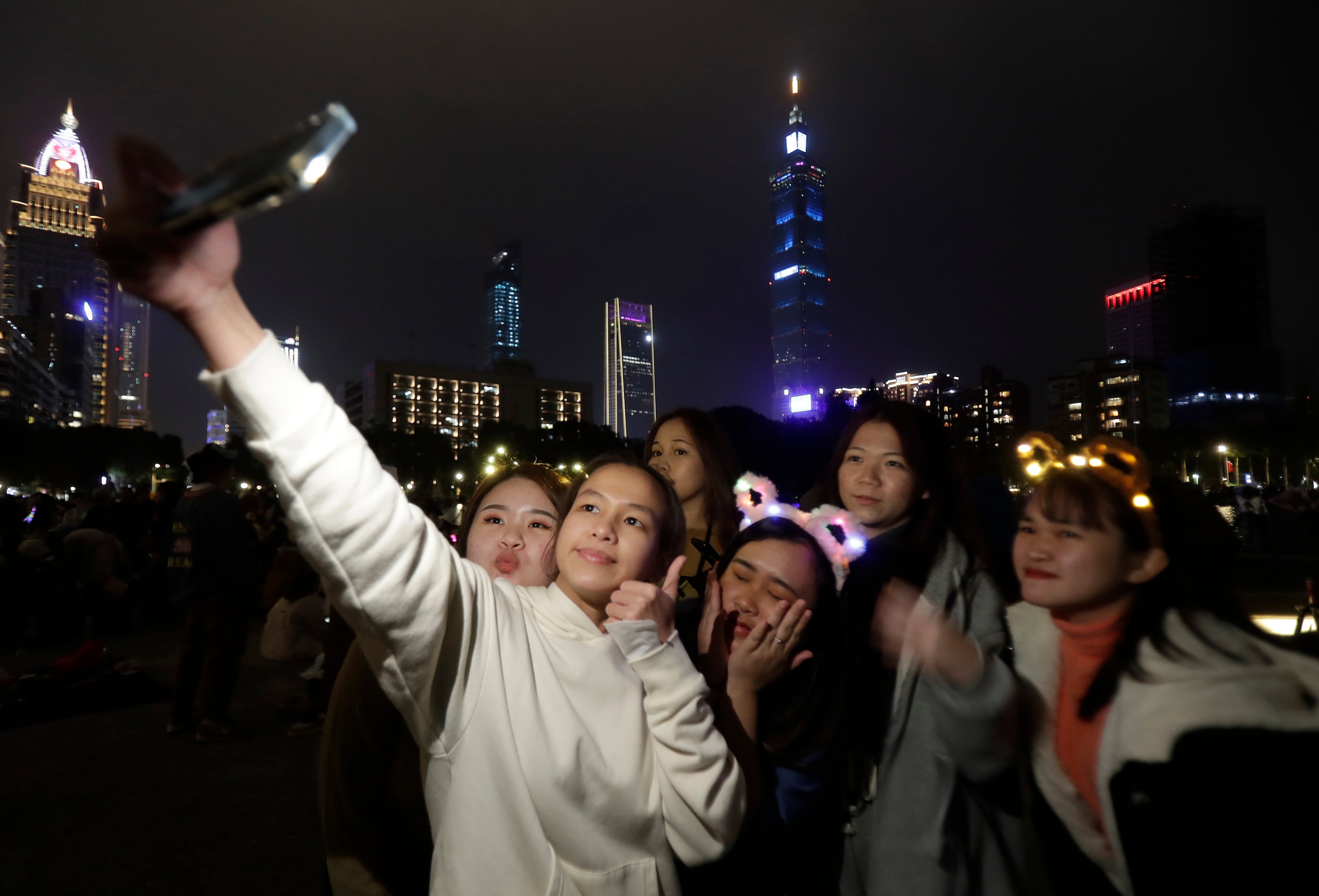 People wear New Year’s costumes and take photo to wait the turn of the year in Taipei, Taiwan