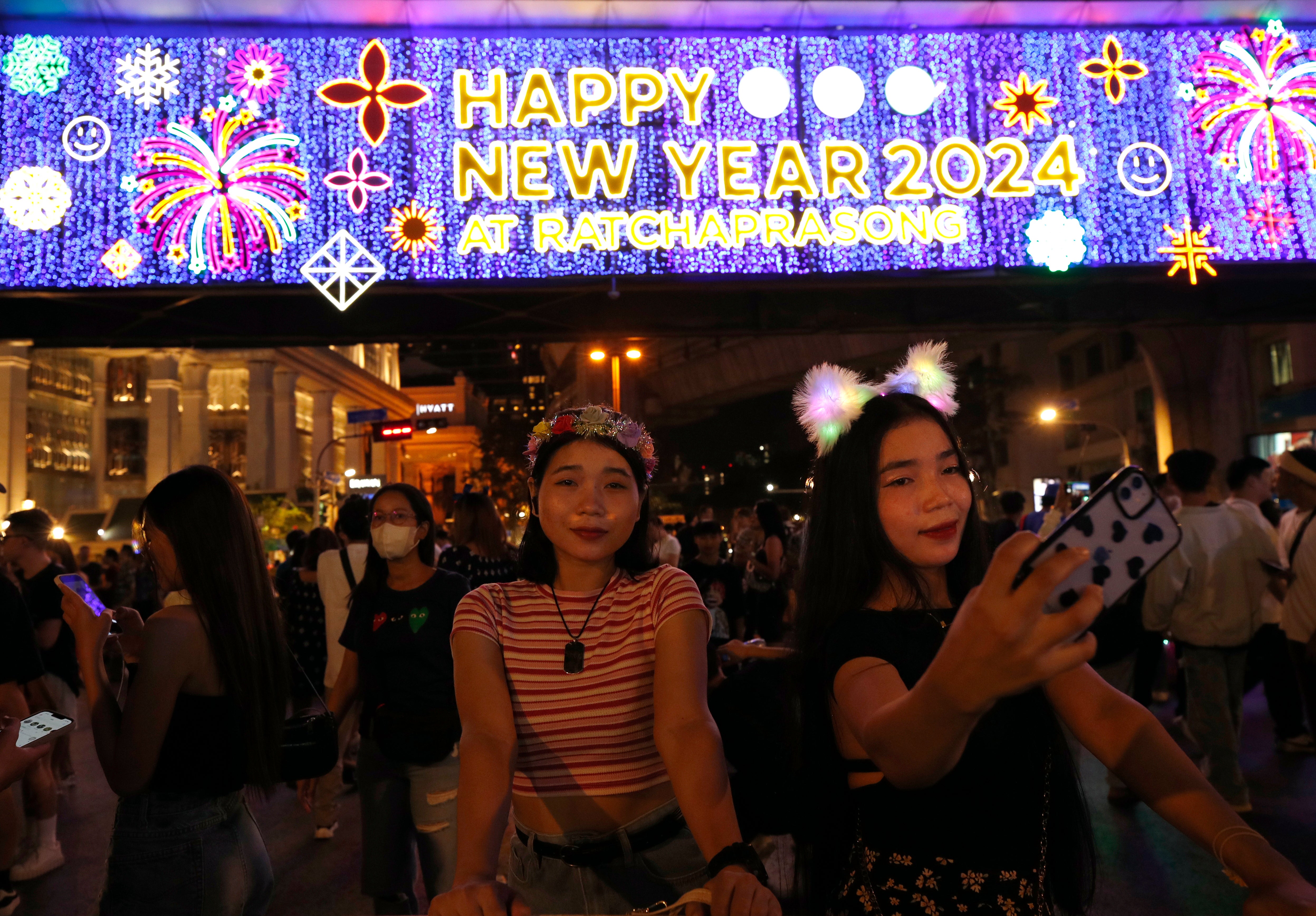 Thai women take selfie photographs to celebrate the New Year’s Eve in Bangkok