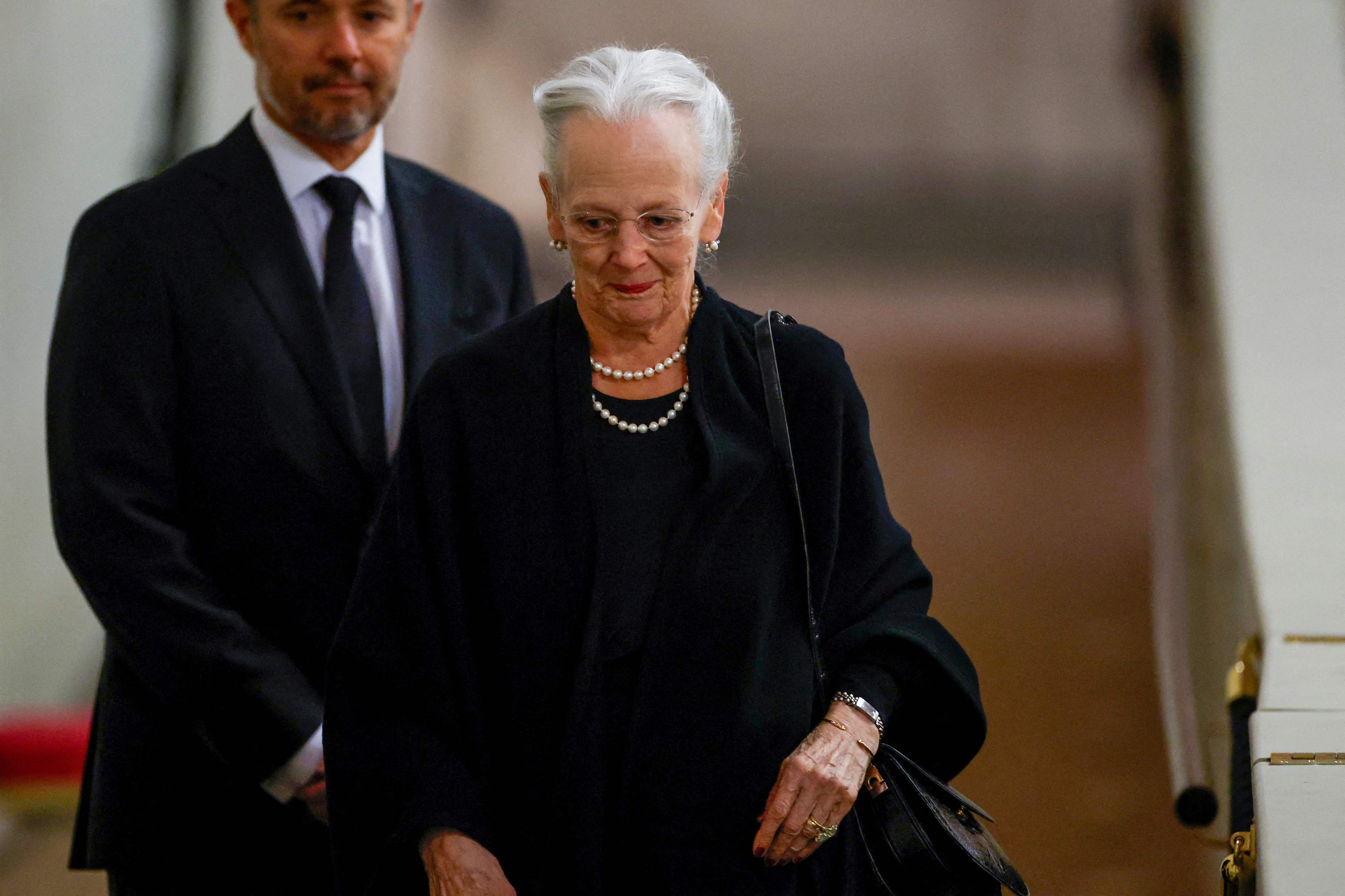 Queen Margrethe II and Prince Frederik pay their respects at the coffin of Queen Elizabeth II