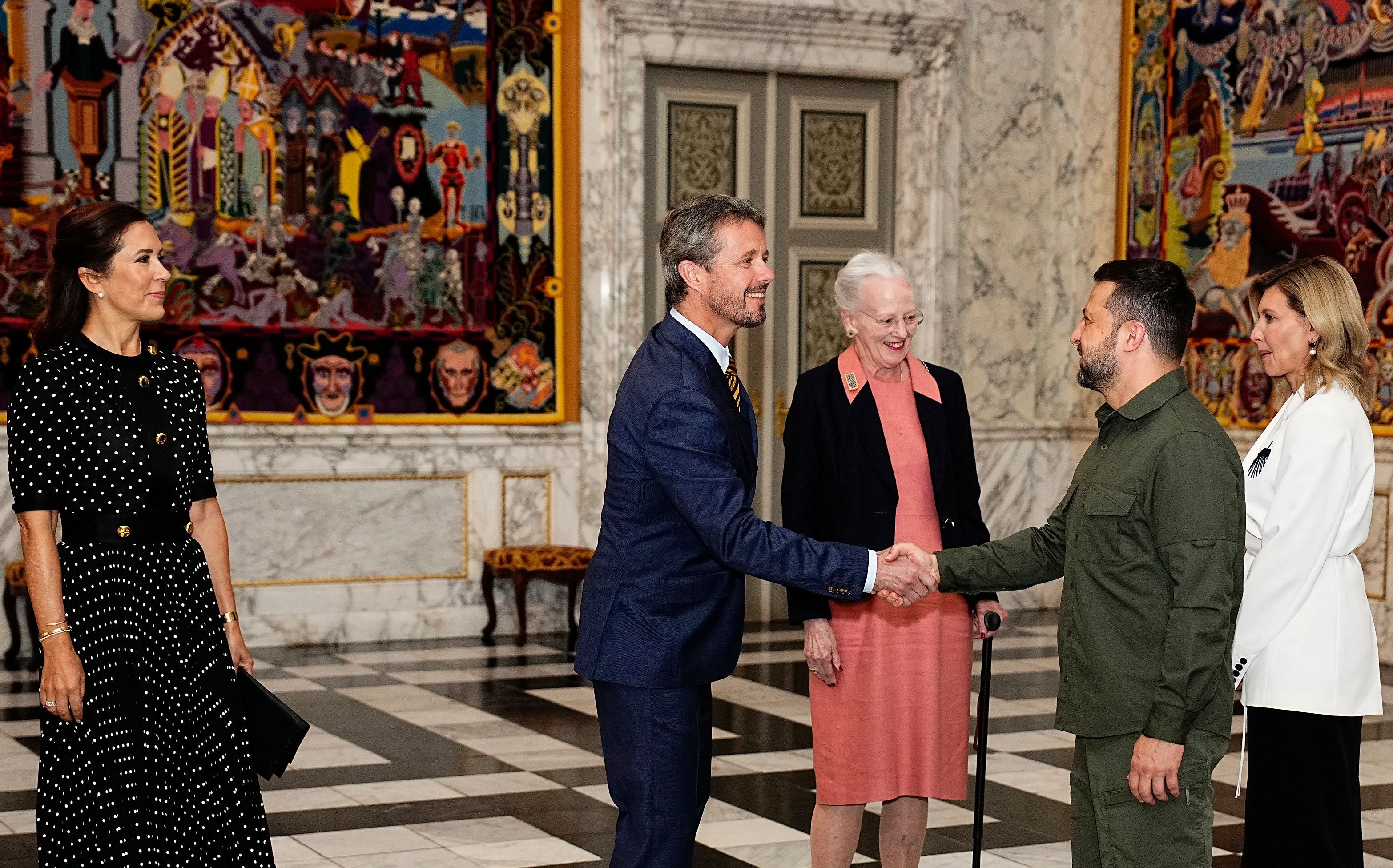 Ukrainian President Volodymyr Zelensky (right) and his wife Ukrainian President Volodymyr Zelensky (right) are received by Prince Frederik and Queen Margrethe II in August