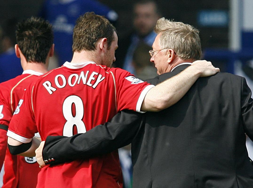 Easier times: Wayne Rooney embraces Sir Alex Ferguson during his time at Manchester United