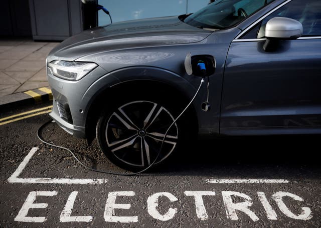 <p>A  Volvo electric vehicle (EV), charges in a bay reserved for electric vehicles in London</p>