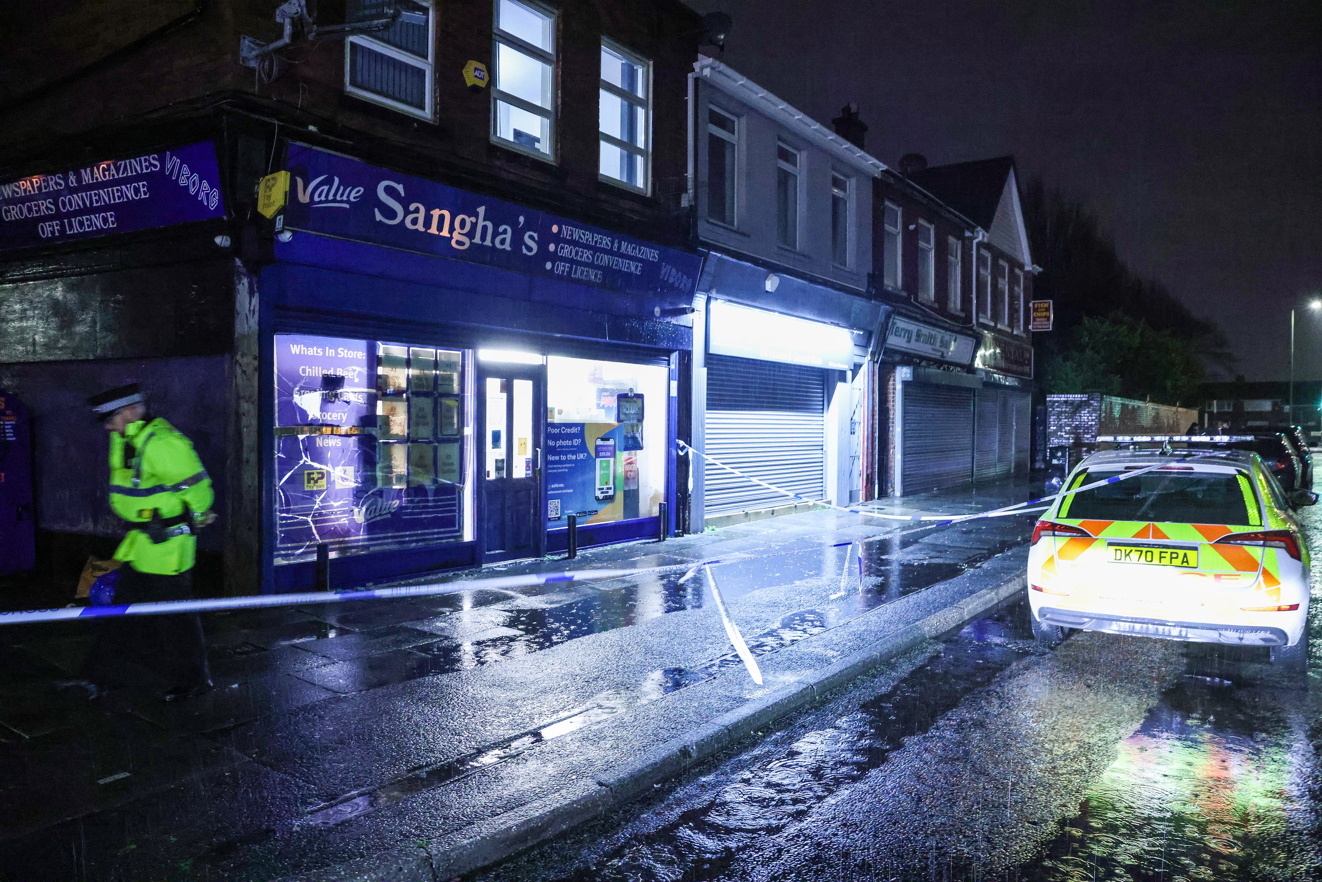 Police outside Sangha’s newsagents where a staff member was threatened