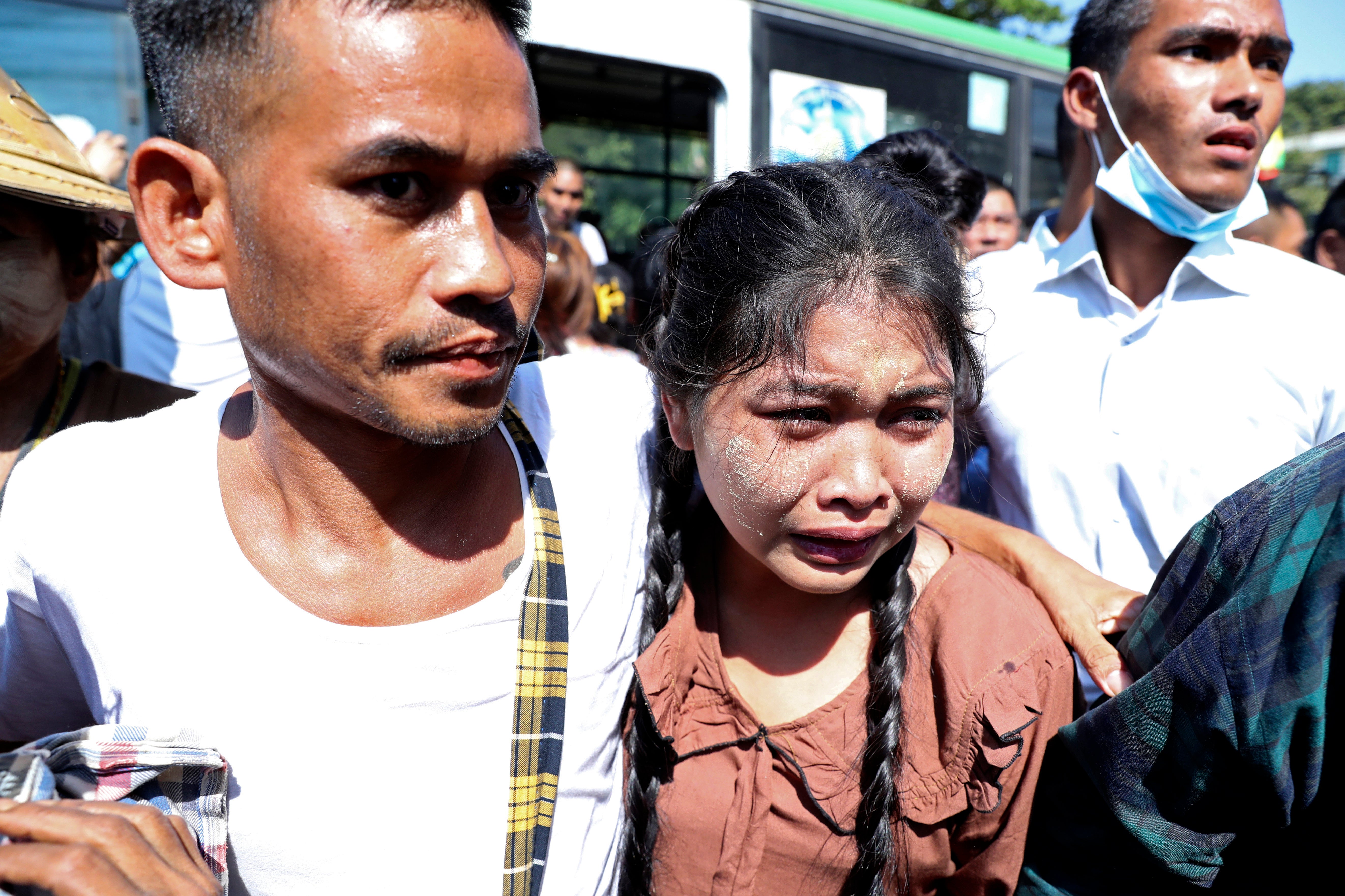 A prisoner, left, is welcomed by family members and colleagues after he was released Insein Prison in Yangon, Myanmar