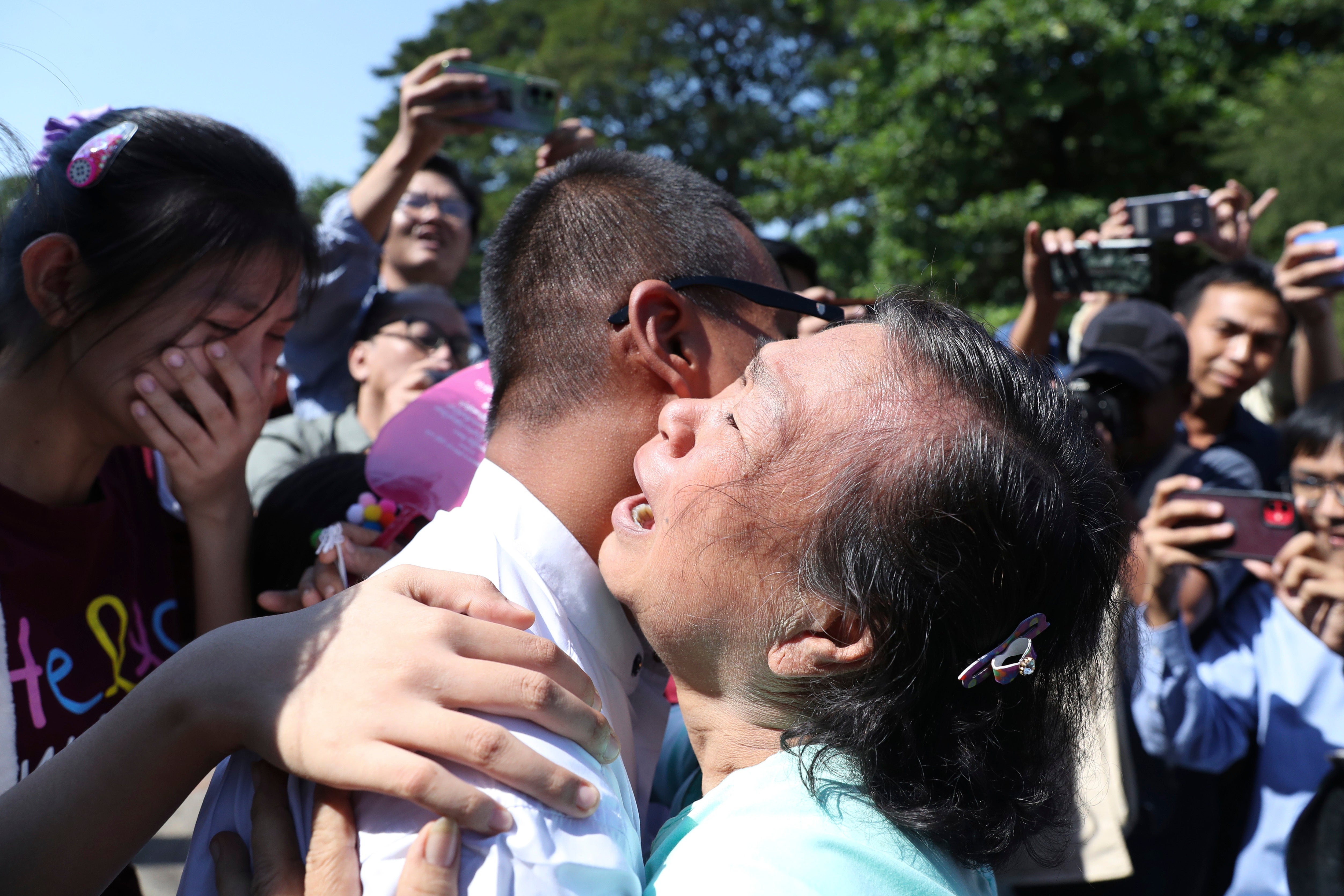 Kaung Sett Lin, centre, photojournalist, is welcomed by family members and colleagues after he was released Insein Prison in Yangon