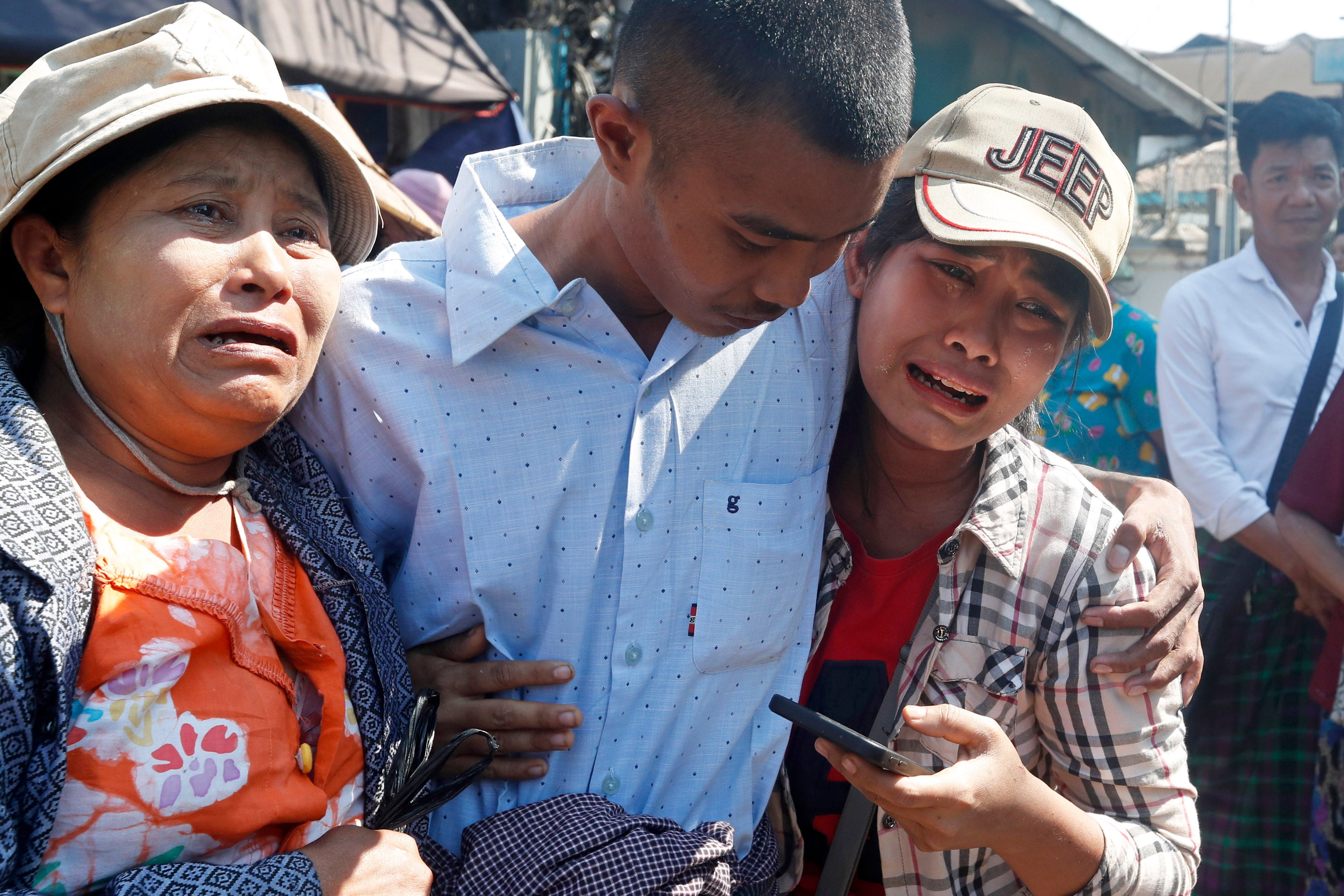 A man hugs family members upon his release from Insein prison in Yangon, Myanmar