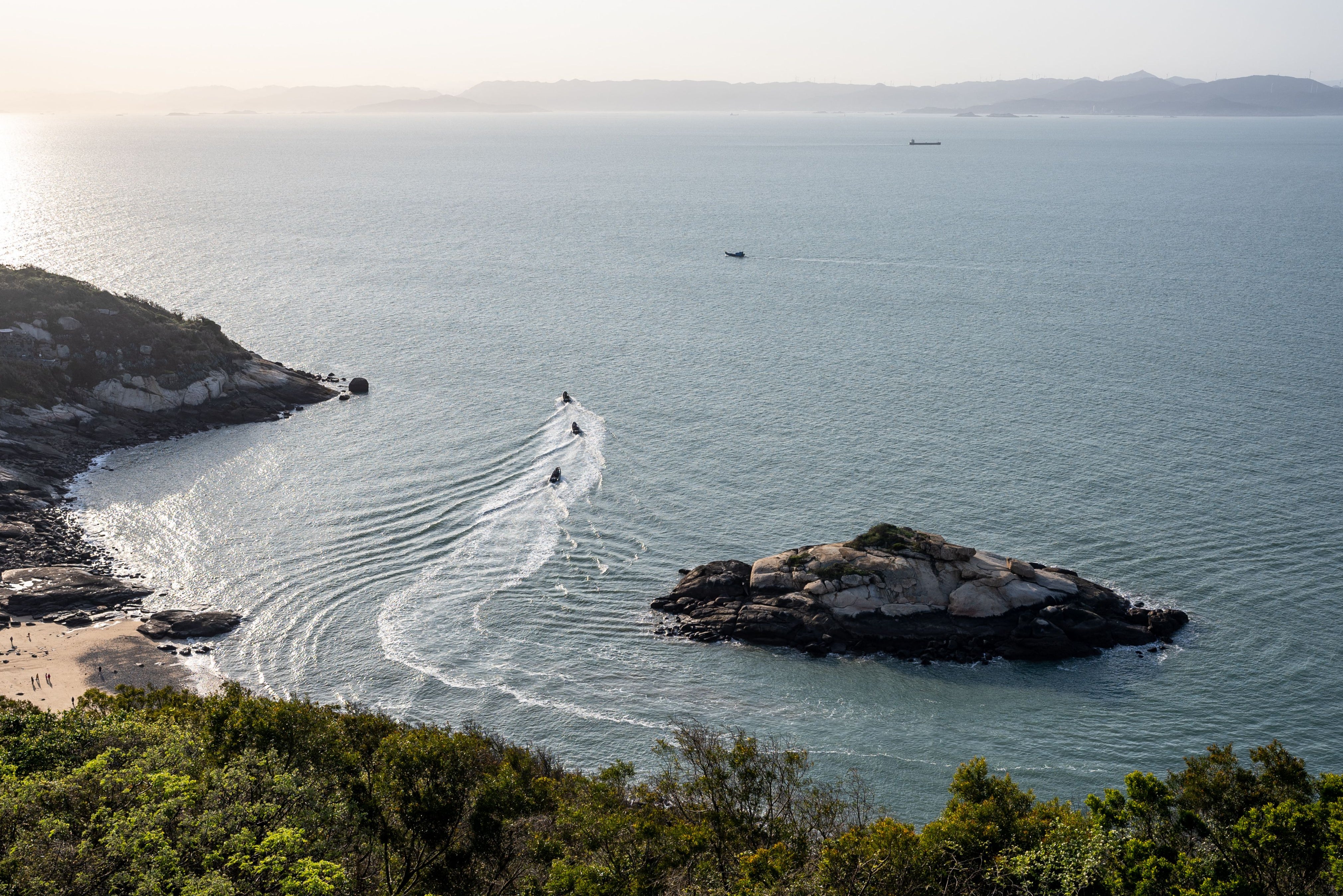 Three military boats from Taiwan’s Amphibious Reconnaissance and Patrol Unit patrol the Matsu Islands with a view of China’s Fujian province in the background