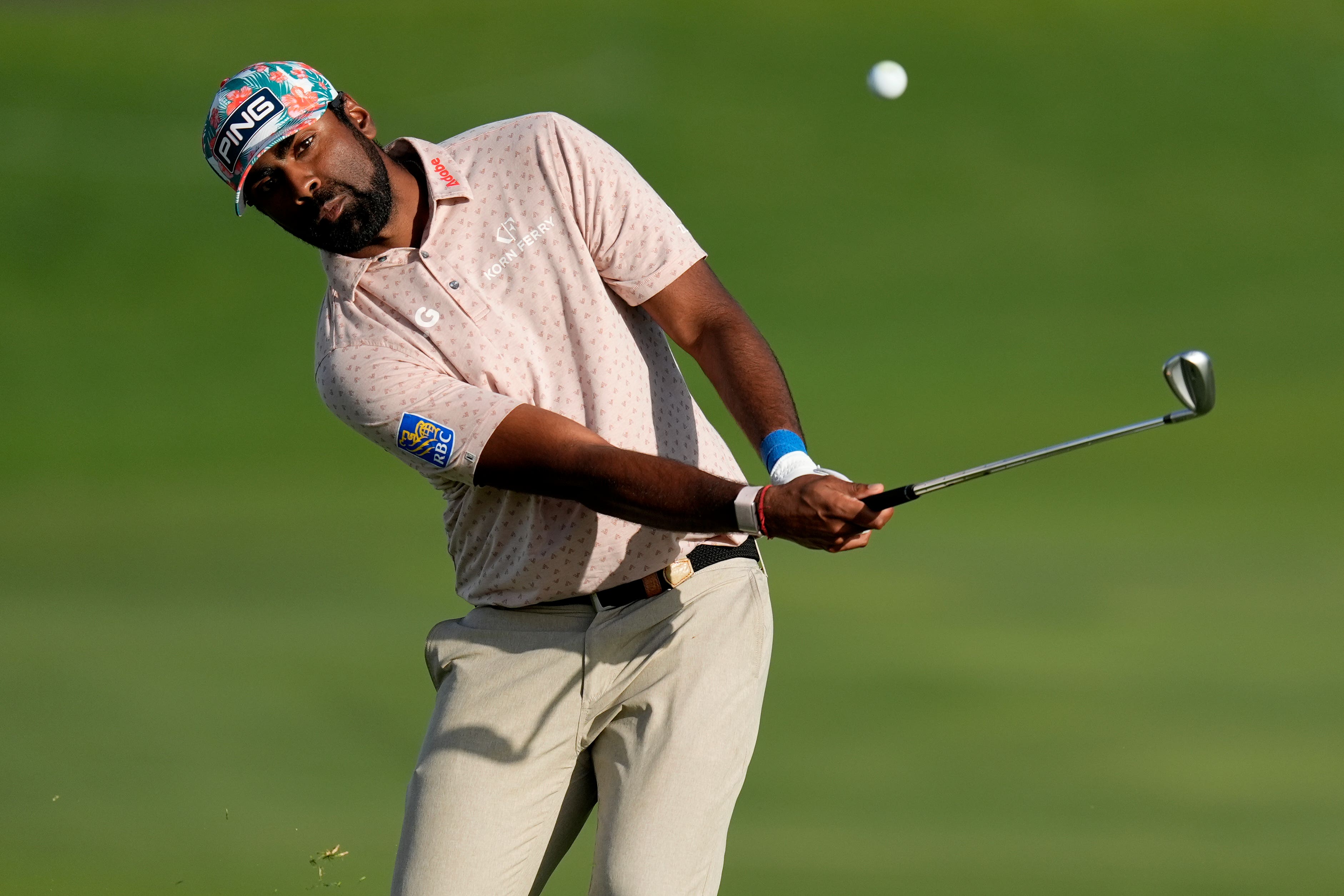 Sahith Theegala hits his approach shot to the 18th (Matt York/AP)