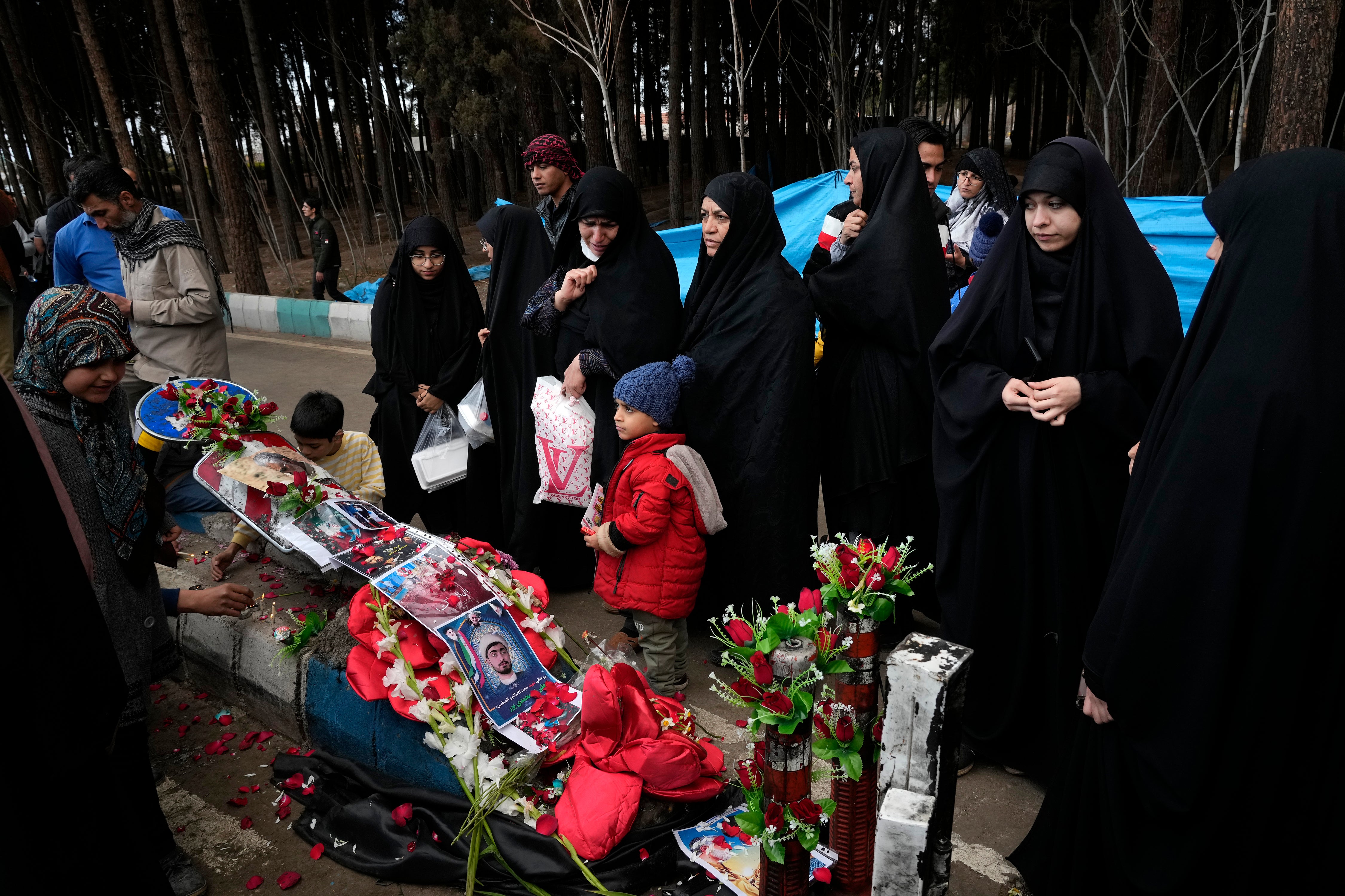 People visit the scene of the bombing in the city of Kerman