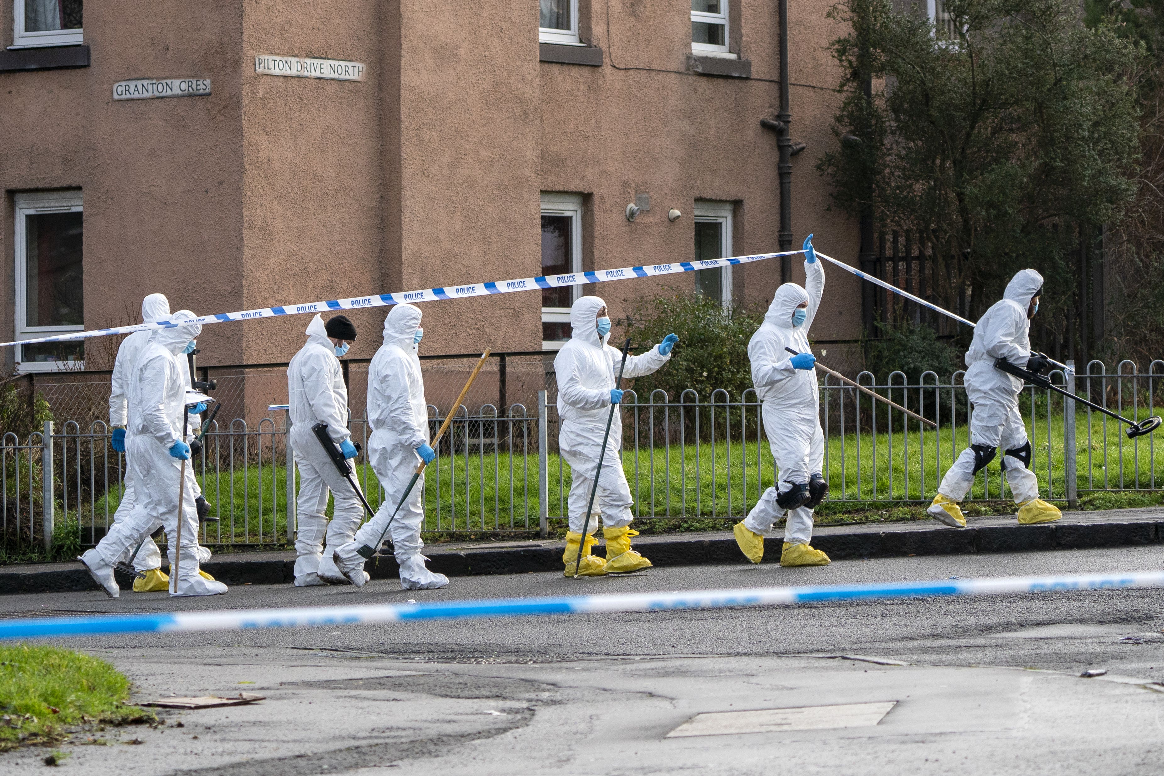 Forensic officers search the area close to the shooting near the Anchor Inn in Granton, Edinburgh (Jane Barlow/PA)