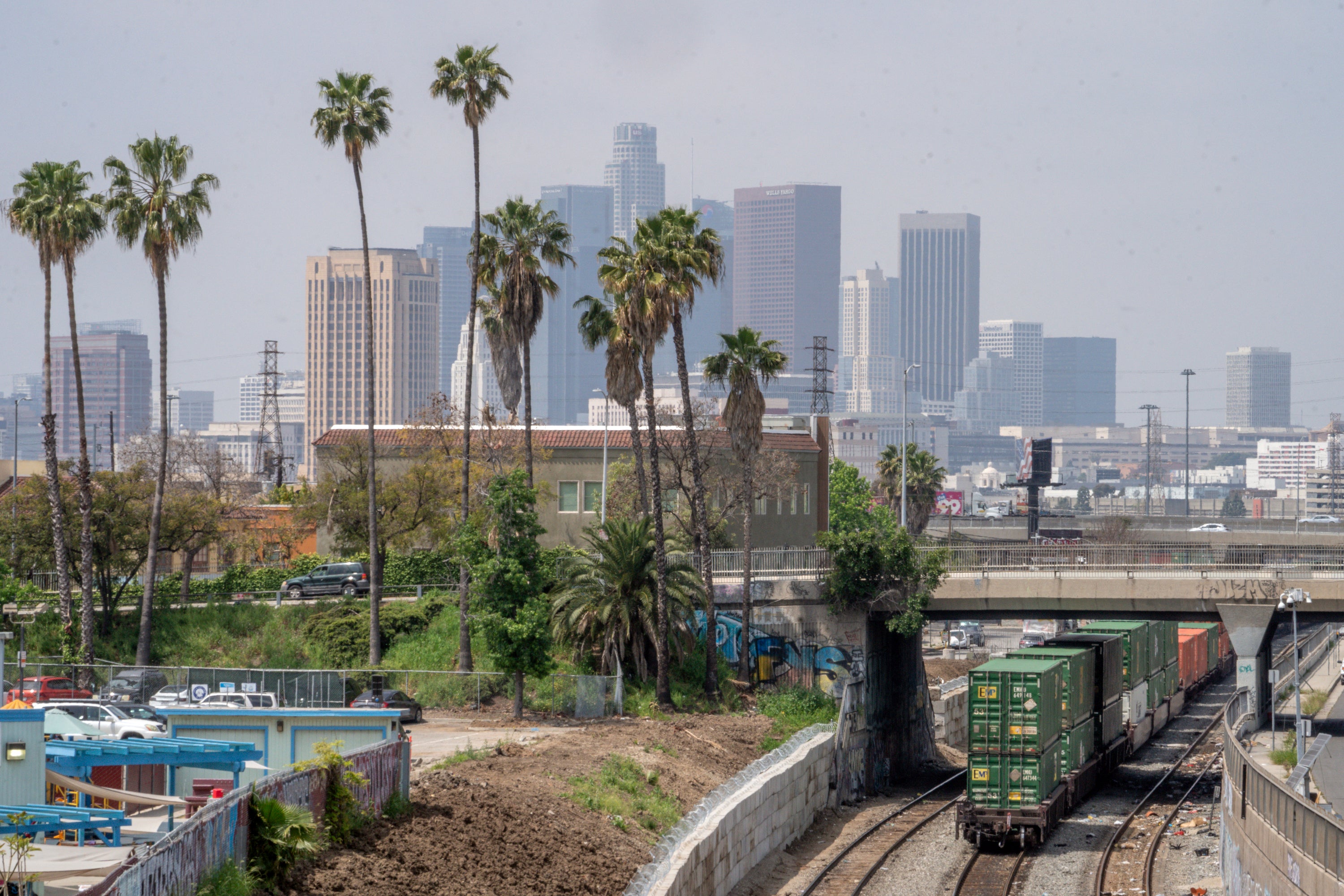 The Los Angeles skyline is seen above a train moving near the Union Pacific LATC Intermodal Terminal in April. There is an excessive heat warning in effect in the Los Angeles region through Monday. The heat has worsened air quality in and around the city.