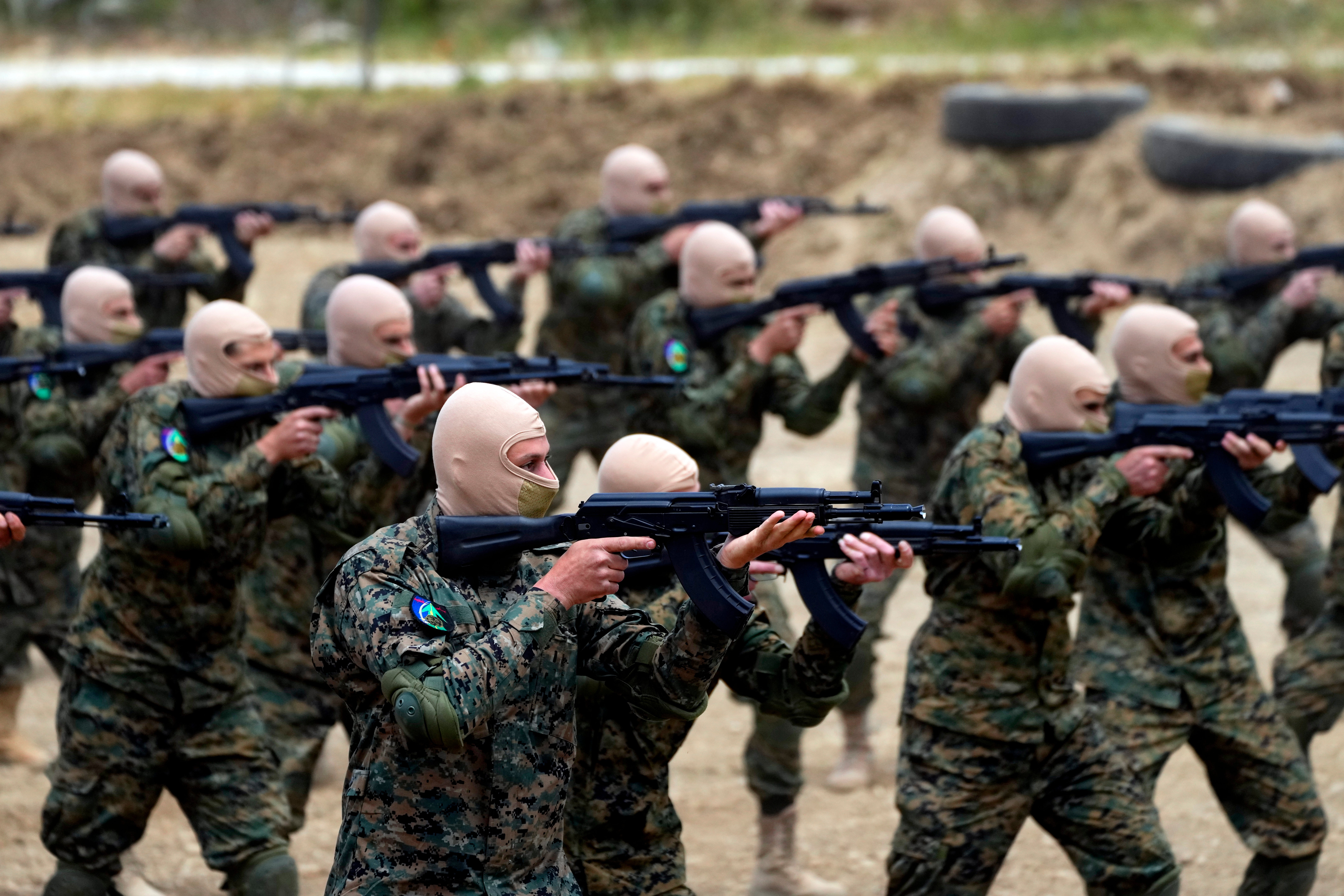 Fighters from the Lebanese militant group Hezbollah carry out a training exercise in Aaramta village in the Jezzine District, southern Lebanon