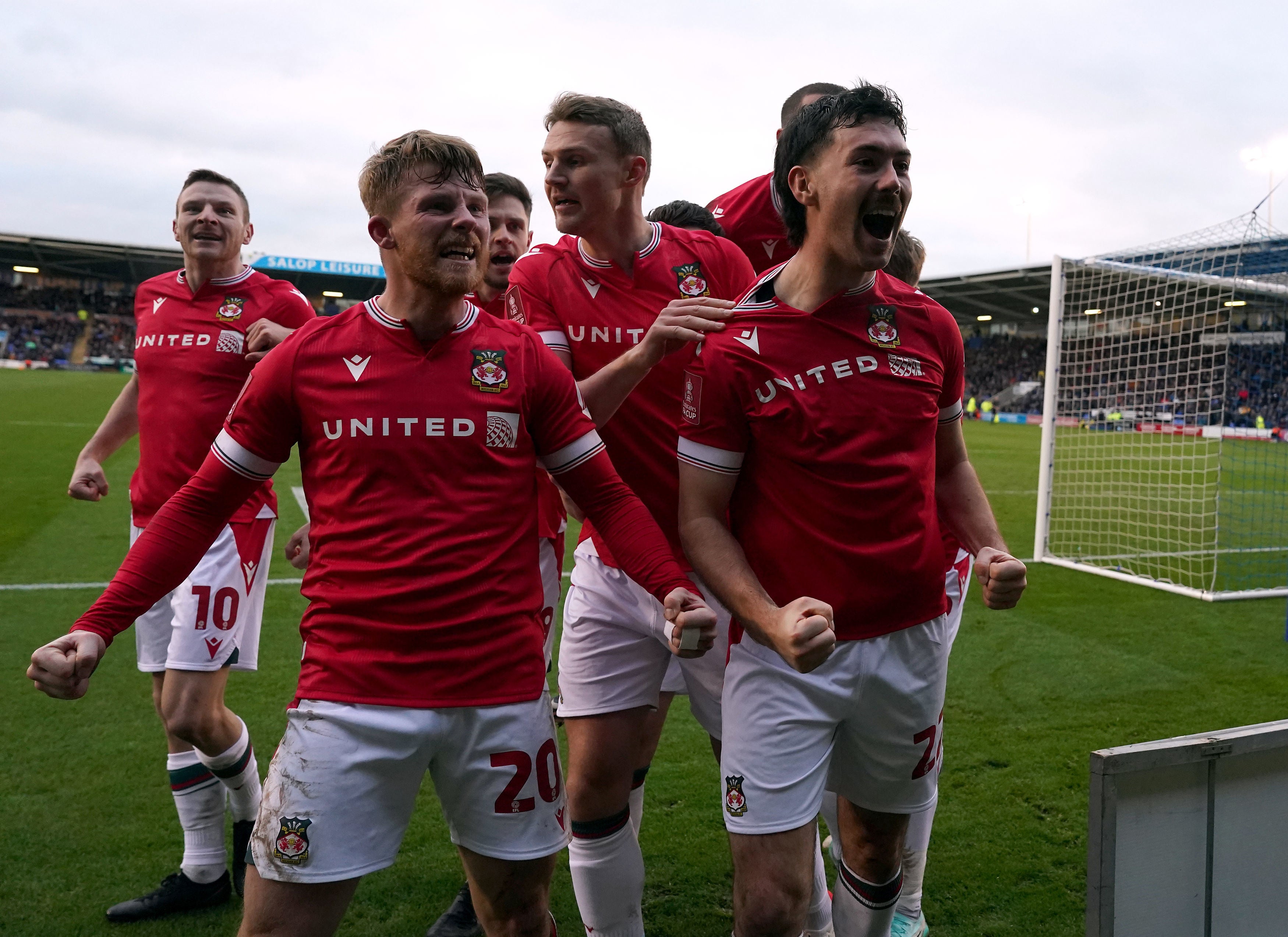 Wrexham's Thomas O'Connor (no.22) celebrates scoring their side's first goal