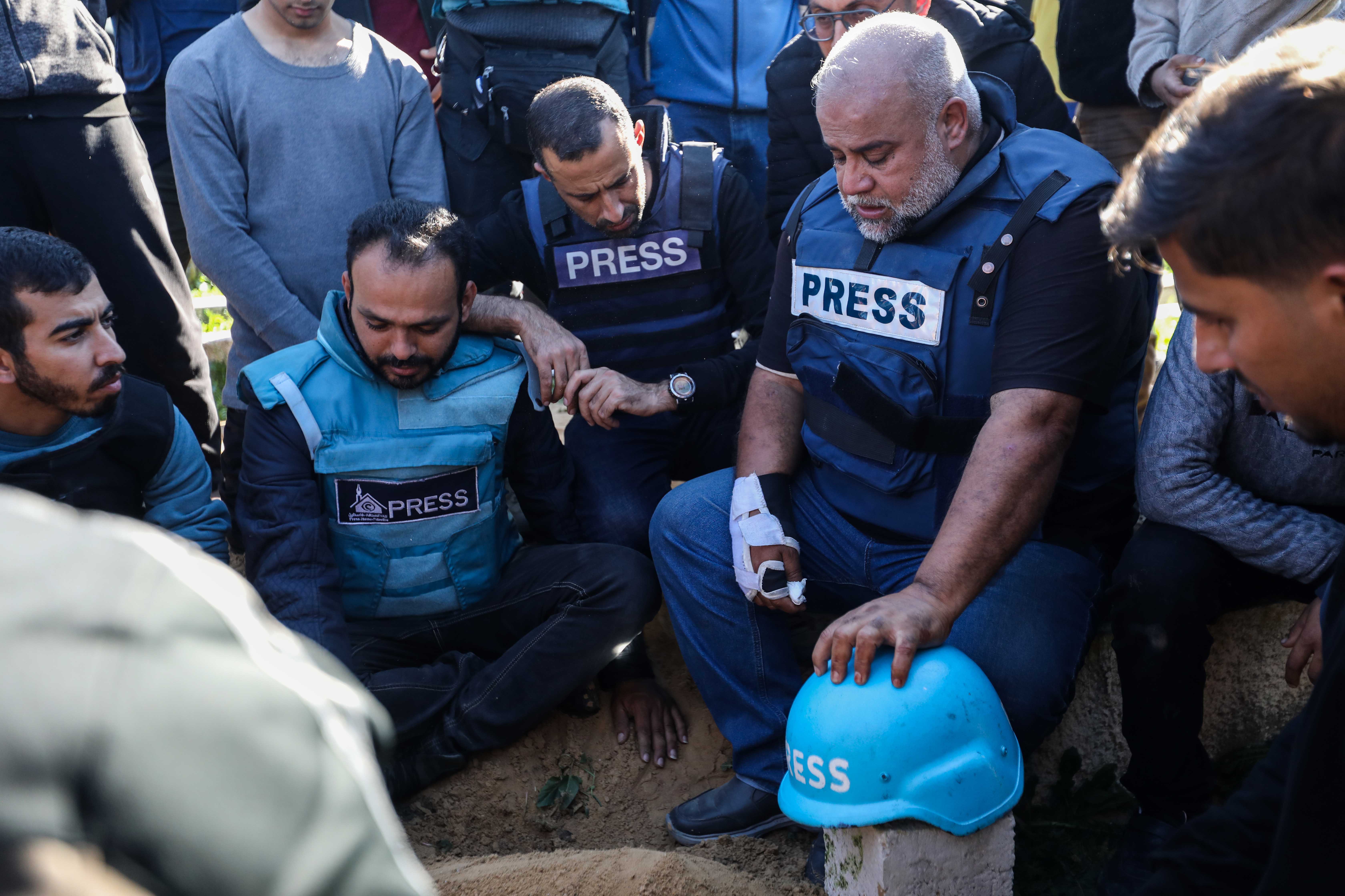 Family and friends including Al Jazeera reporter Wael Al-Dahdouh (second right) bid farewell to the bodies of journalists Hamza Al-Dahdouh and Mustafa Thuraya killed in Gaza in January