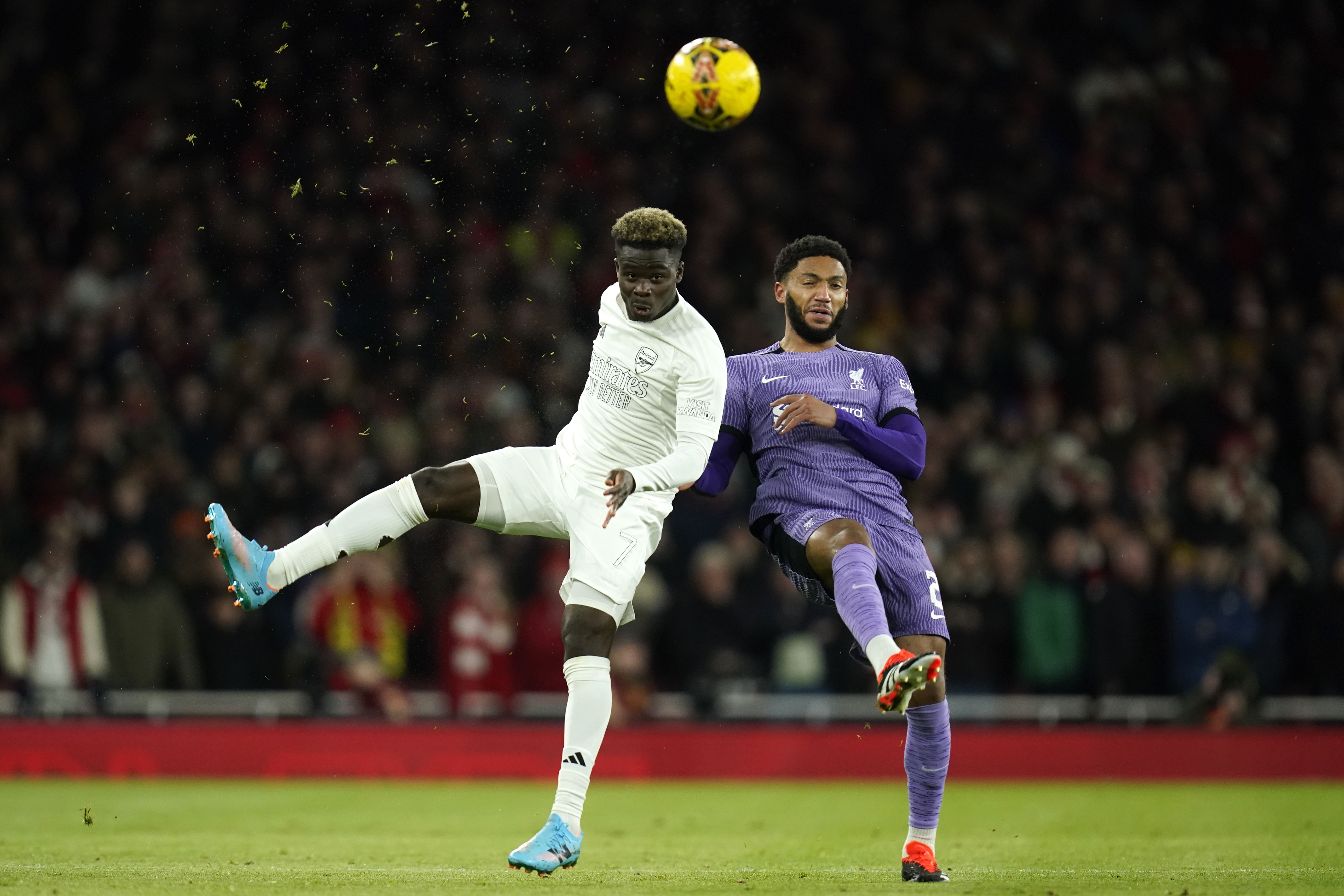 Liverpool defender Joe Gomez battles with Arsenal’s Bukayo Saka during their 2-0 win in the FA Cup (Andrew Matthews/PA)