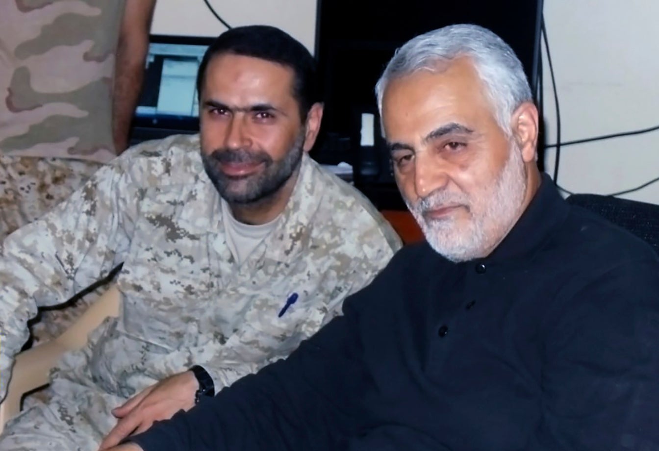 Senior Hezbollah commander Wissam Tawil, left, killed in Lebanon in January this year, sitting next to Iran's Quds force General Qassem Soleimani