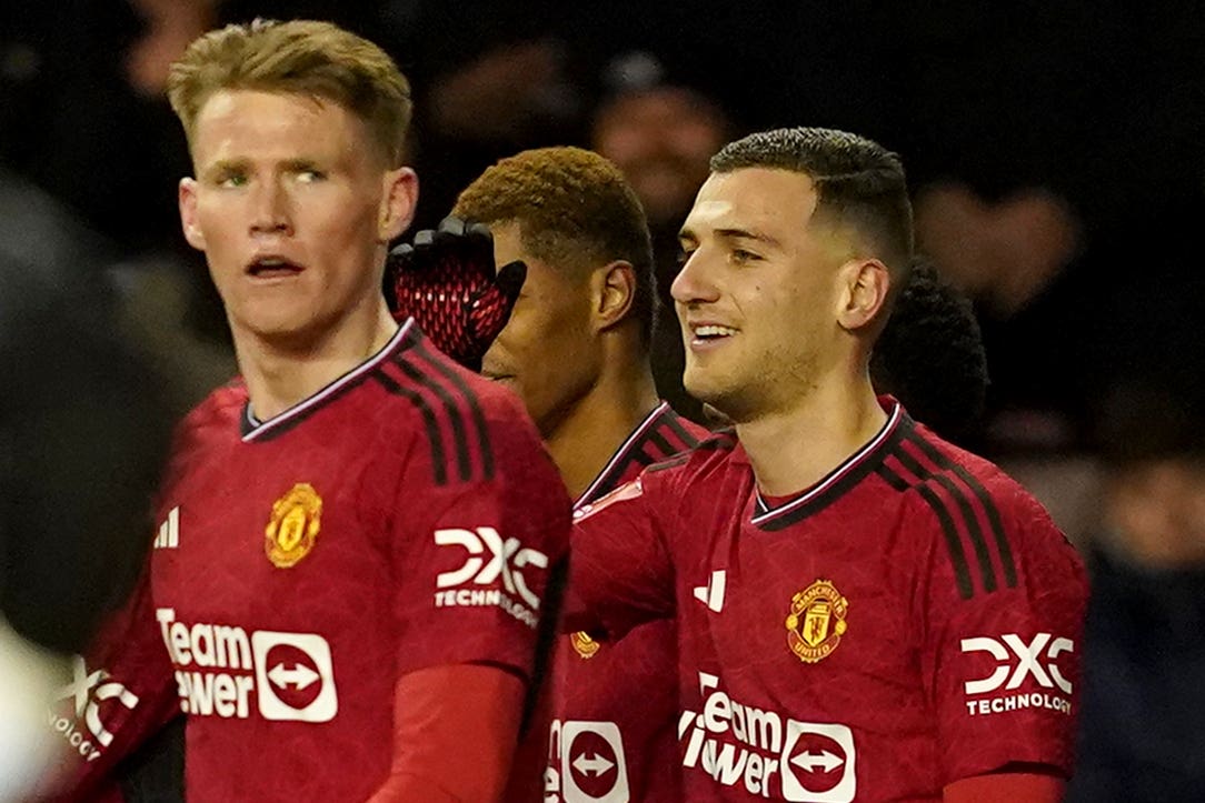 Diogo Dalot (right) celebrates scoring United’s opener (Martin Rickett/PA)